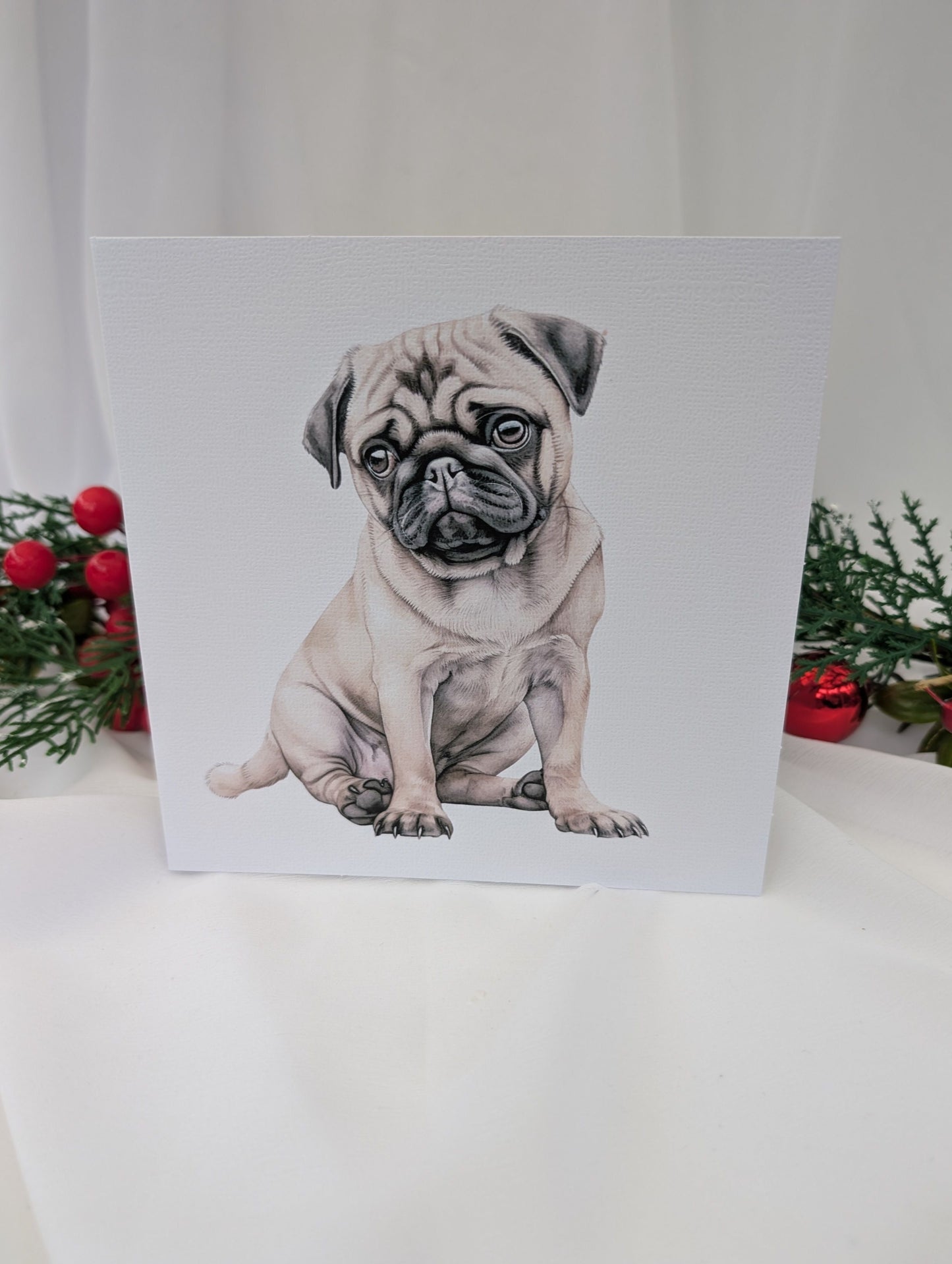 6 x 6 inch white linen effect greeting card printed with watercolour style image of a cute pug puppy
