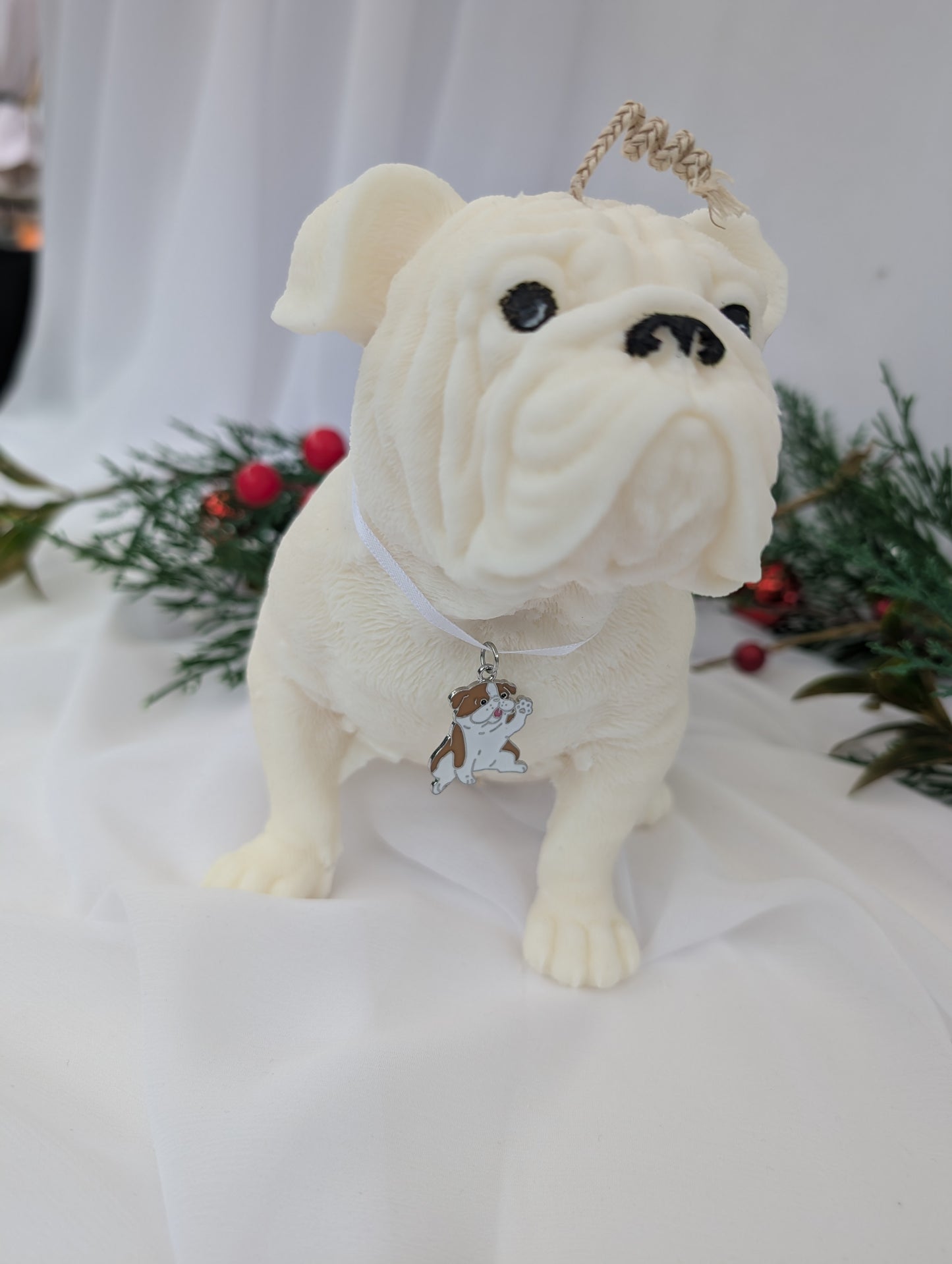 Right Side view of hand poured moulded British Bulldog Candle with white ribbon and British bulldog charm around its neck