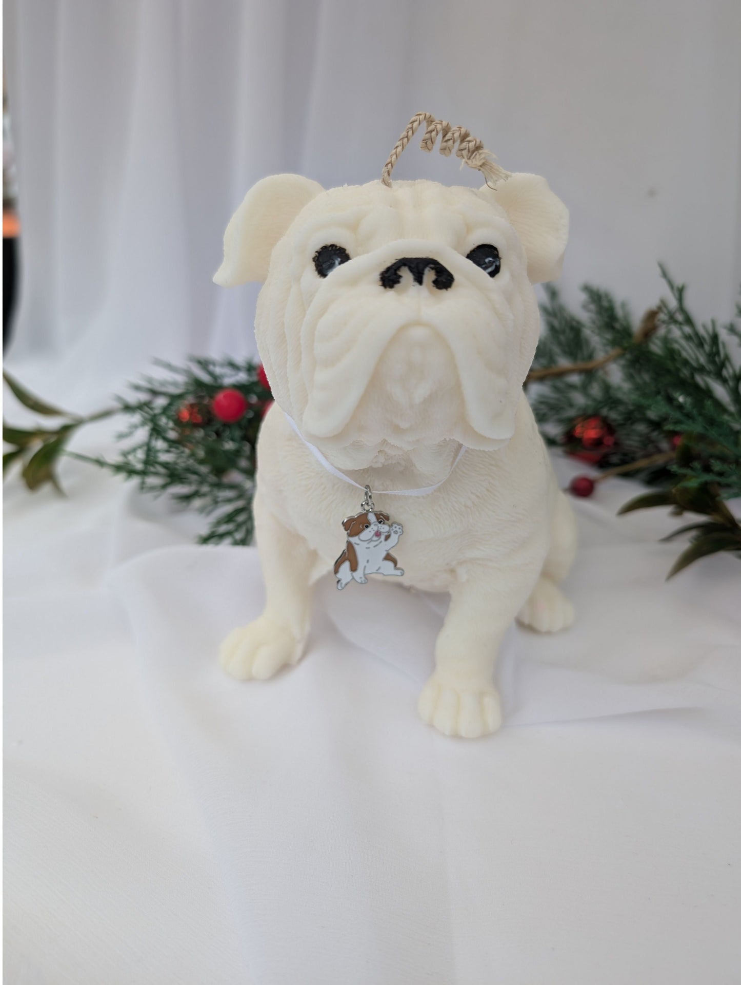 Front view of hand poured moulded British Bulldog Candle with white ribbon and British bulldog charm around its neck
