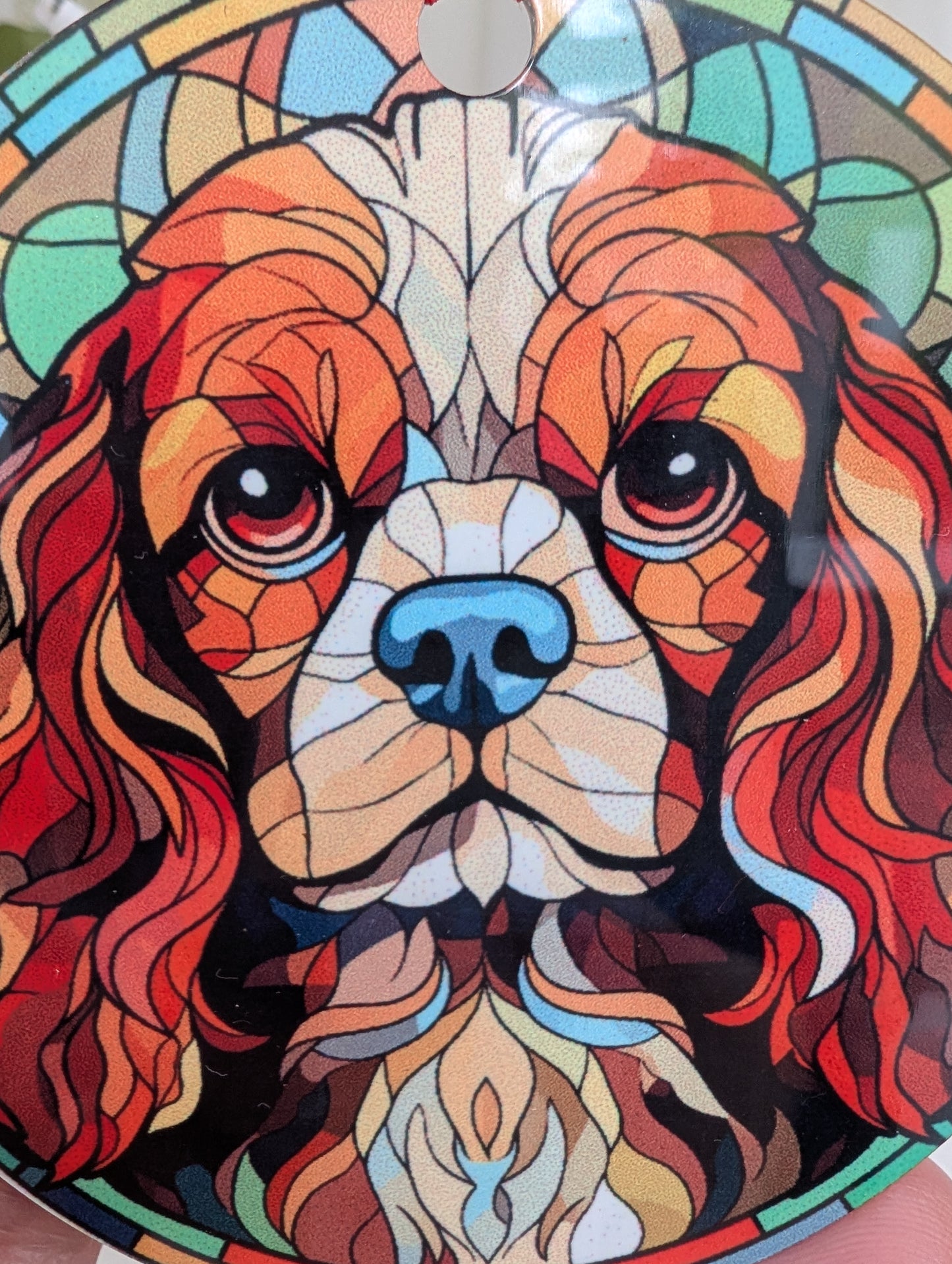 Close up detail of Cavalier King Charles hanging ornament featuring a stunning stained glass style design.