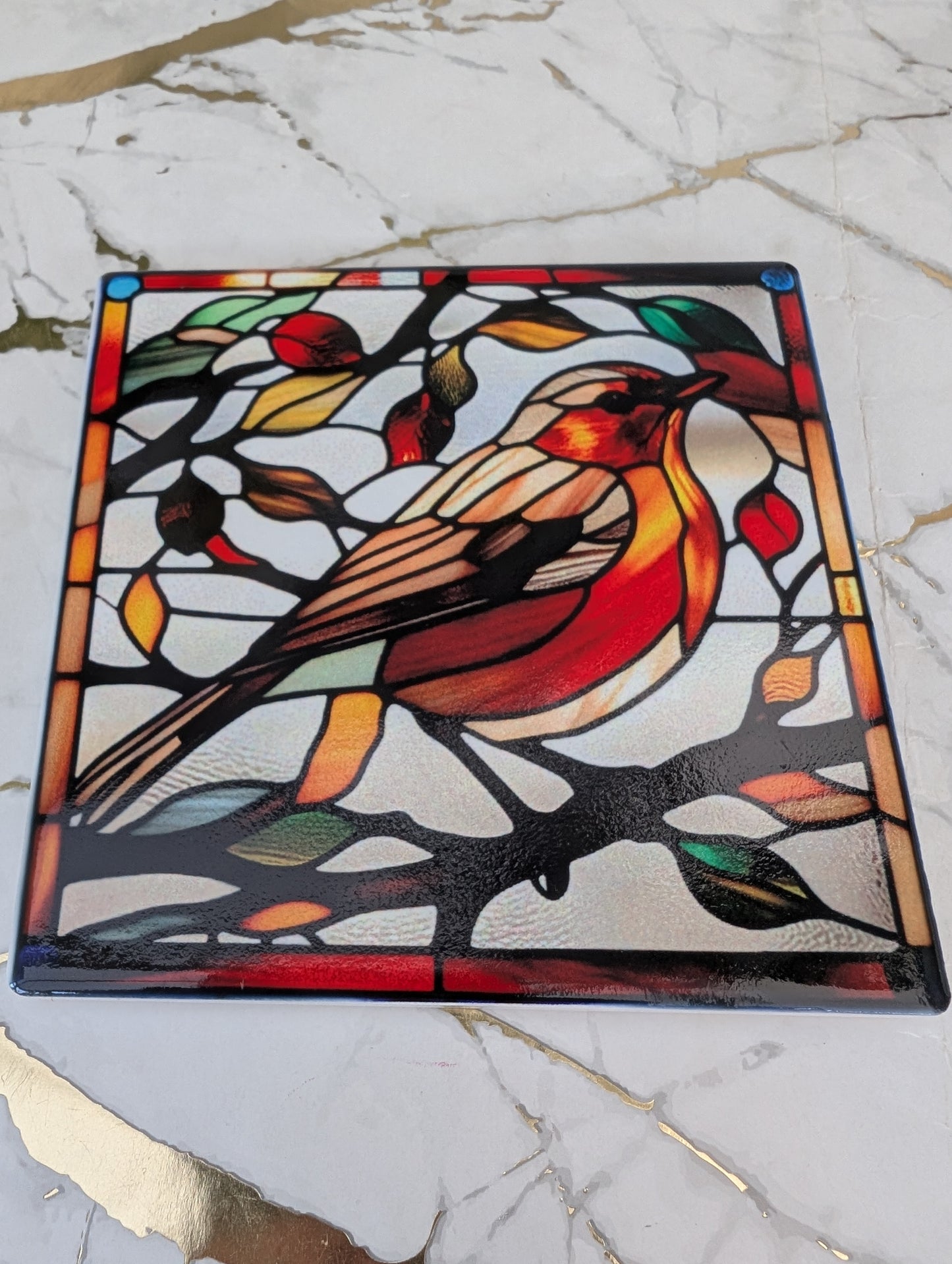 Close up view of square ceramic stained glass style Robin Coaster