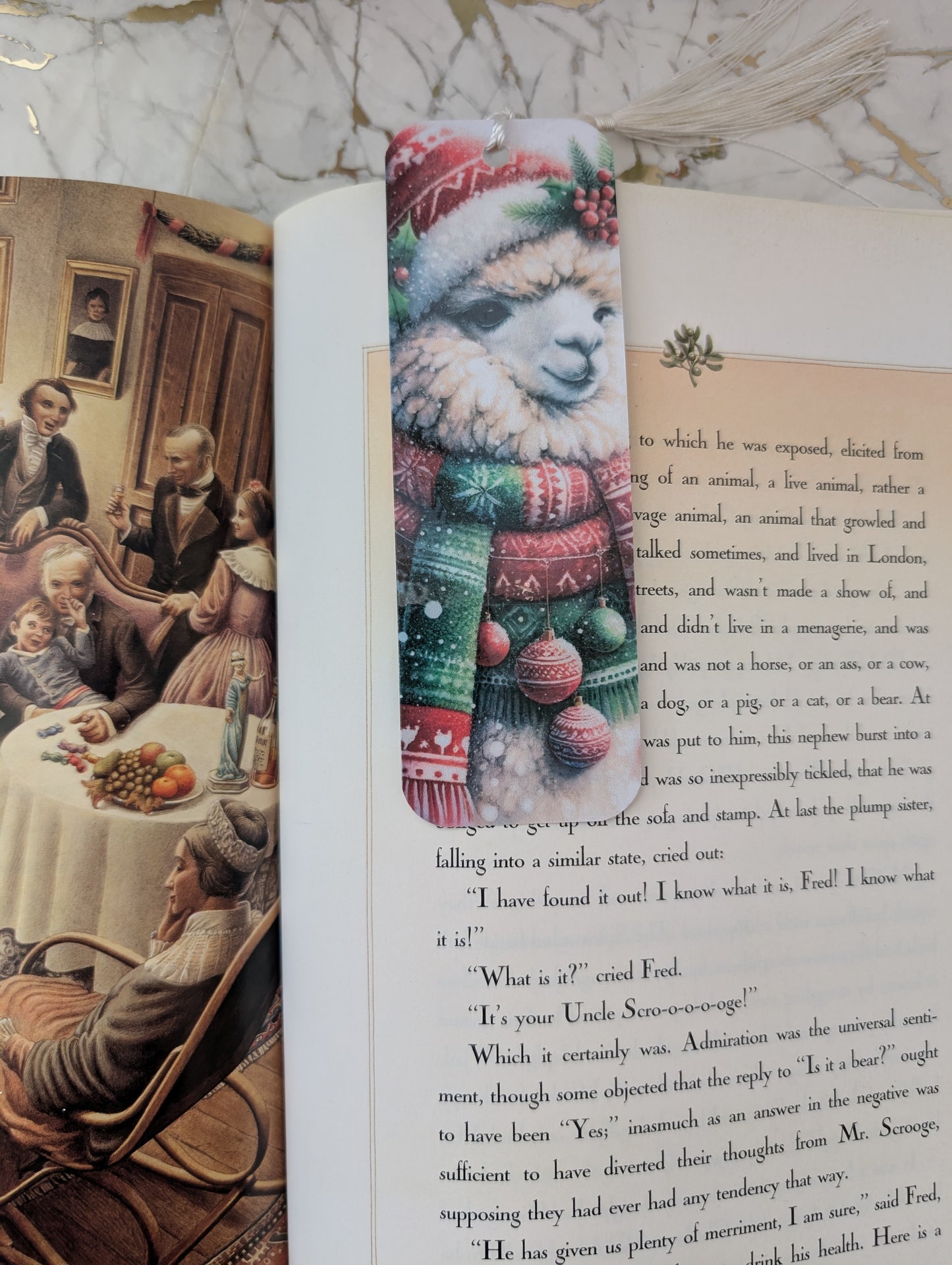 Book with a Christmas-themed llama bookmark on a marble surface