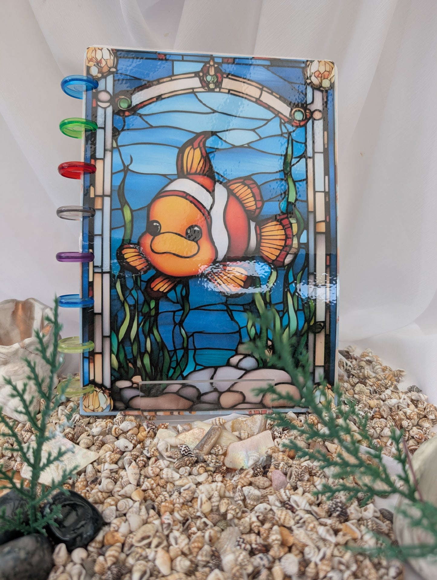 Stained glass refillable notebook with a clownfish on a white background