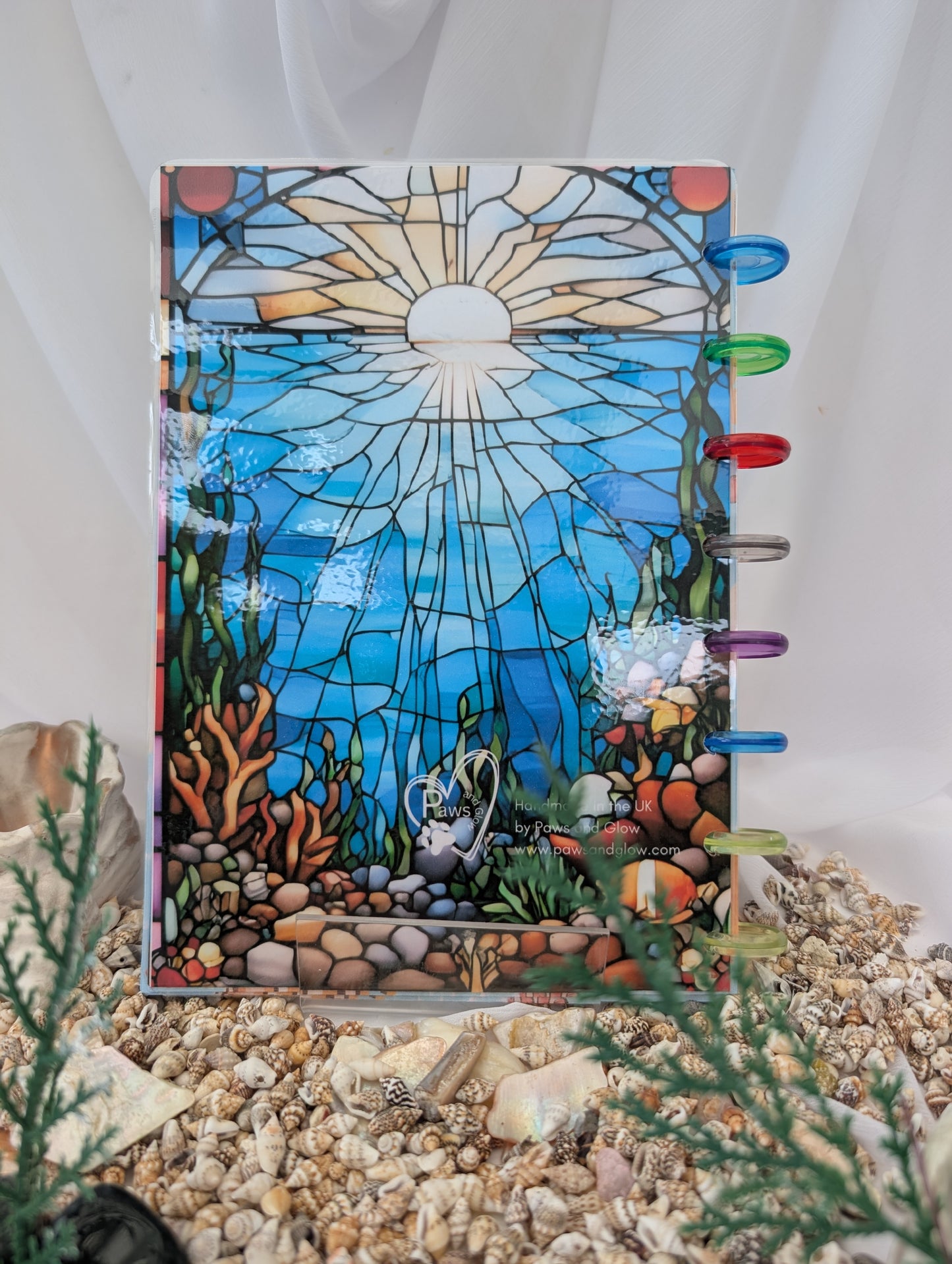 Stained glass-style notebook with underwater scene design on a white background