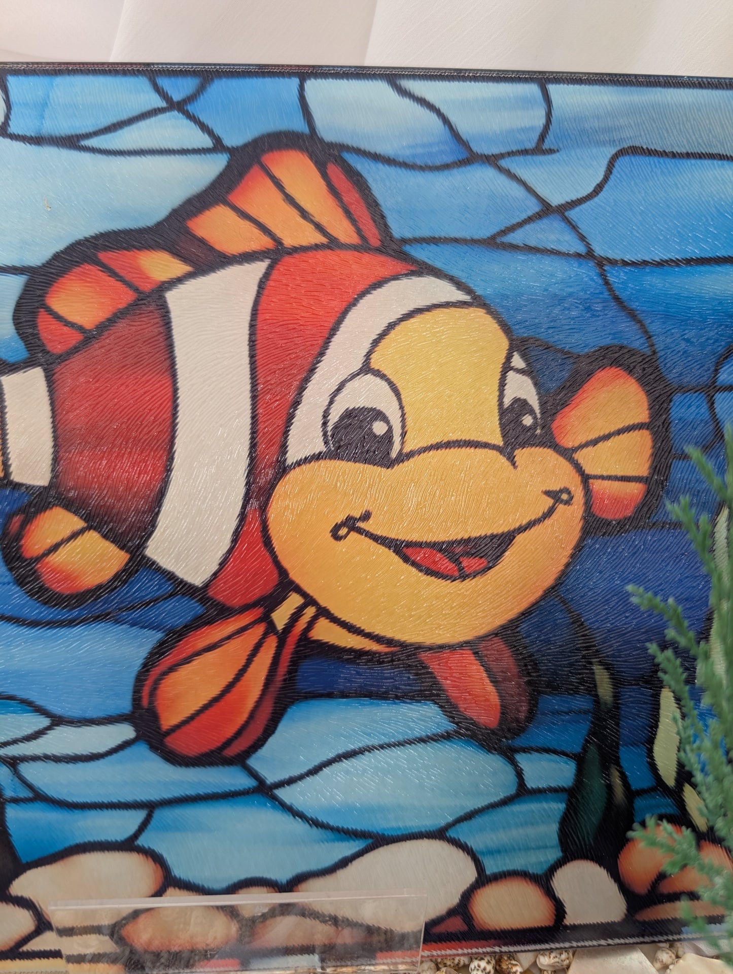 Colorful clownfish chopping board on a blue background