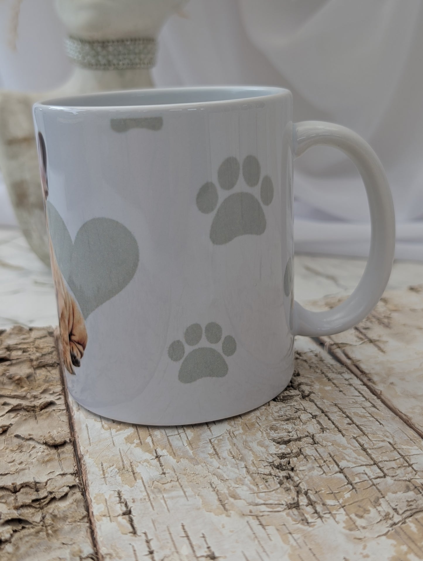 Left side view of Ceramic Dog mug with fabulous watercolour image of tan and white French Bulldog against a background of soft grey colour hearts, bones and pawprints.