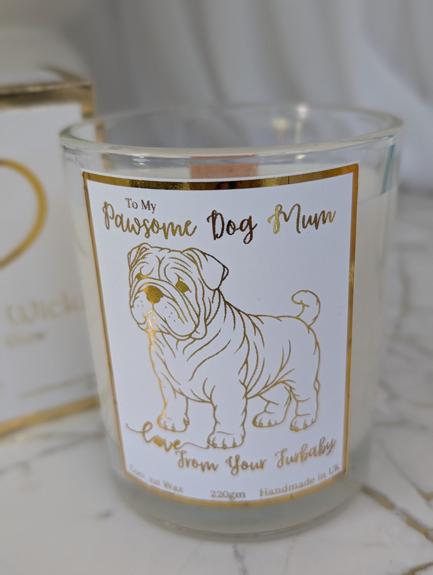 Close up of Pawsome Dog Mum Love from your furbaby candle - Bulldog mum candle in clear glass container with gold foiled label