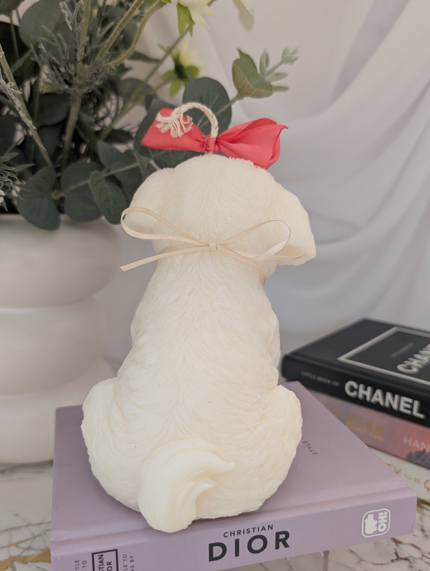 Back view of dog shaped candle - shih tzu natural colour coconut and rapeseed wax with pink ribbon and removable charm