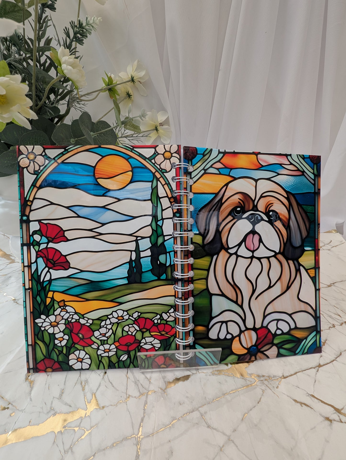 Dog Notedbook - Stained glass-style notebook with a shih tzu illustration on a marble surface with flowers.