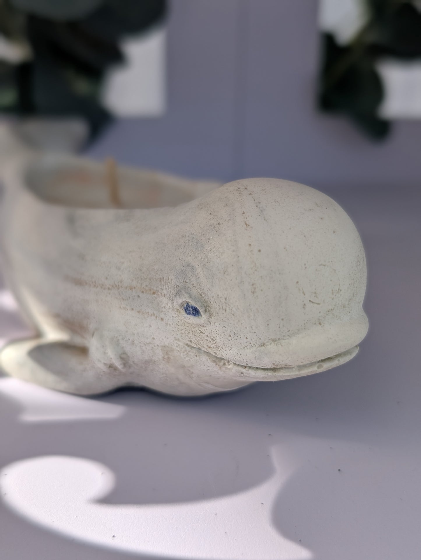 Dolphin ornament on a light surface with a blurred background