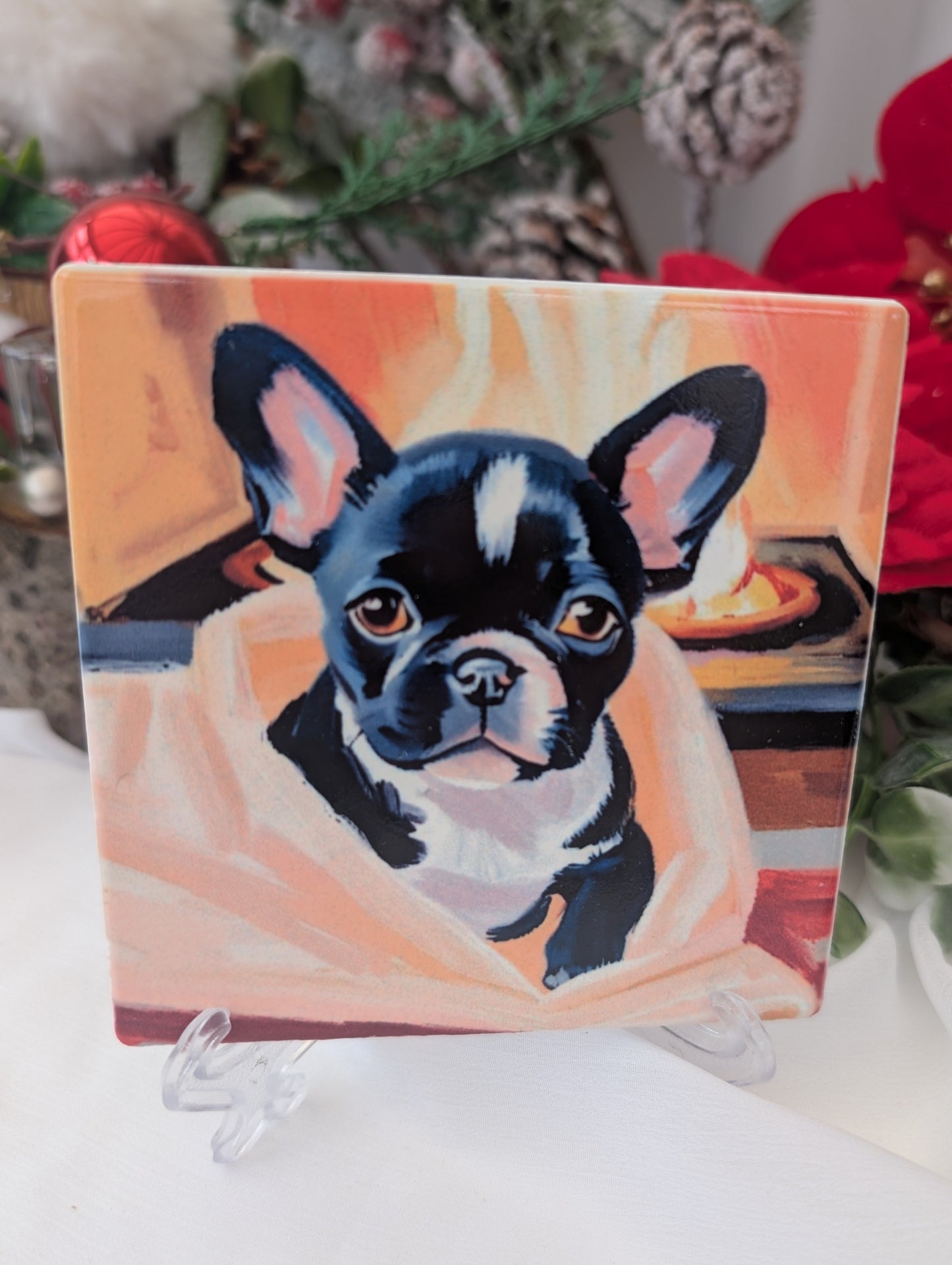French Bulldog gift idea - glass coaster with black and white French bulldog peeping out of a blanket in front of a fire