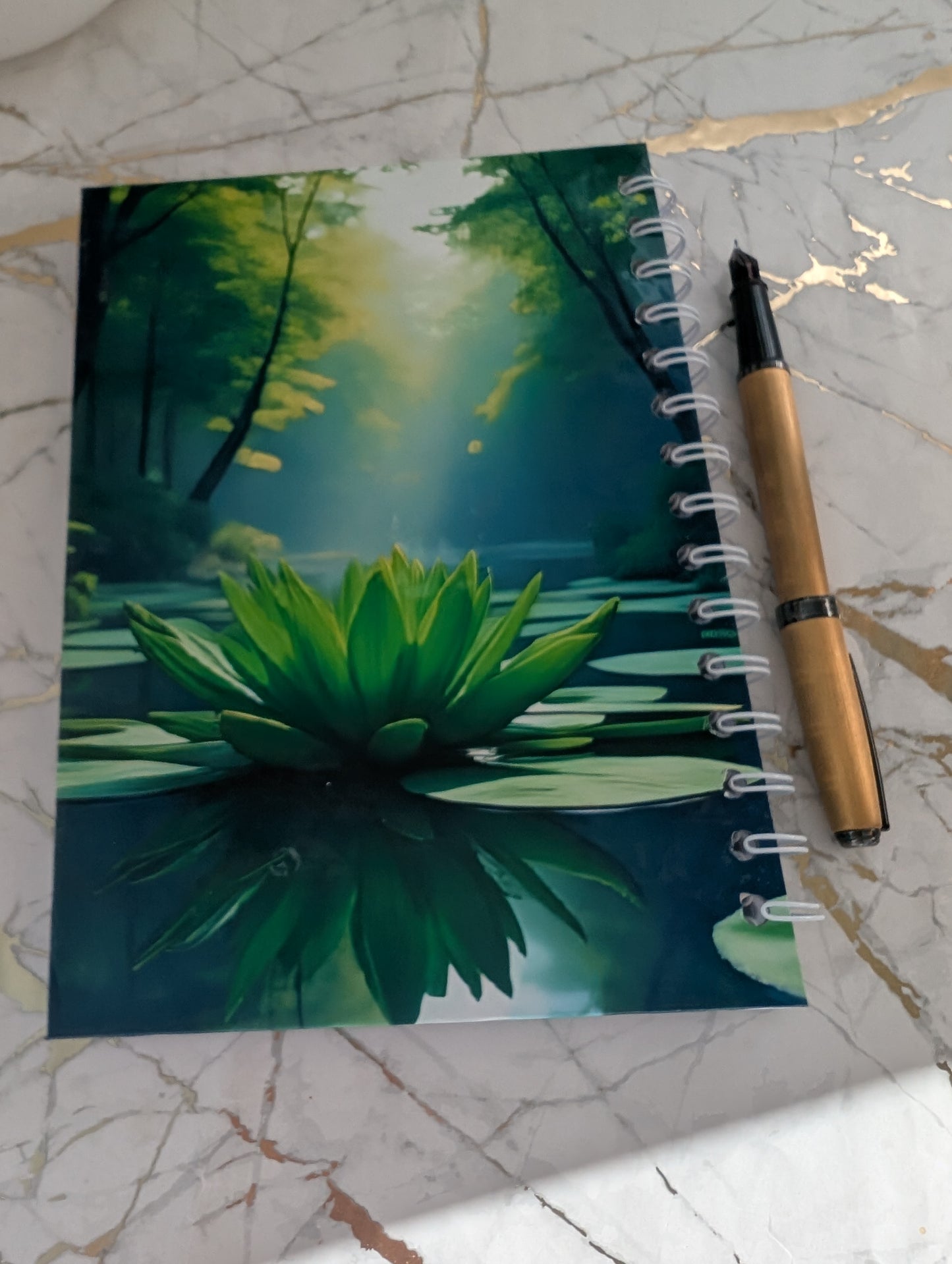 Back cover view of a handmade, glossy hardback cover notebook, featuring a beautiful lilypad design