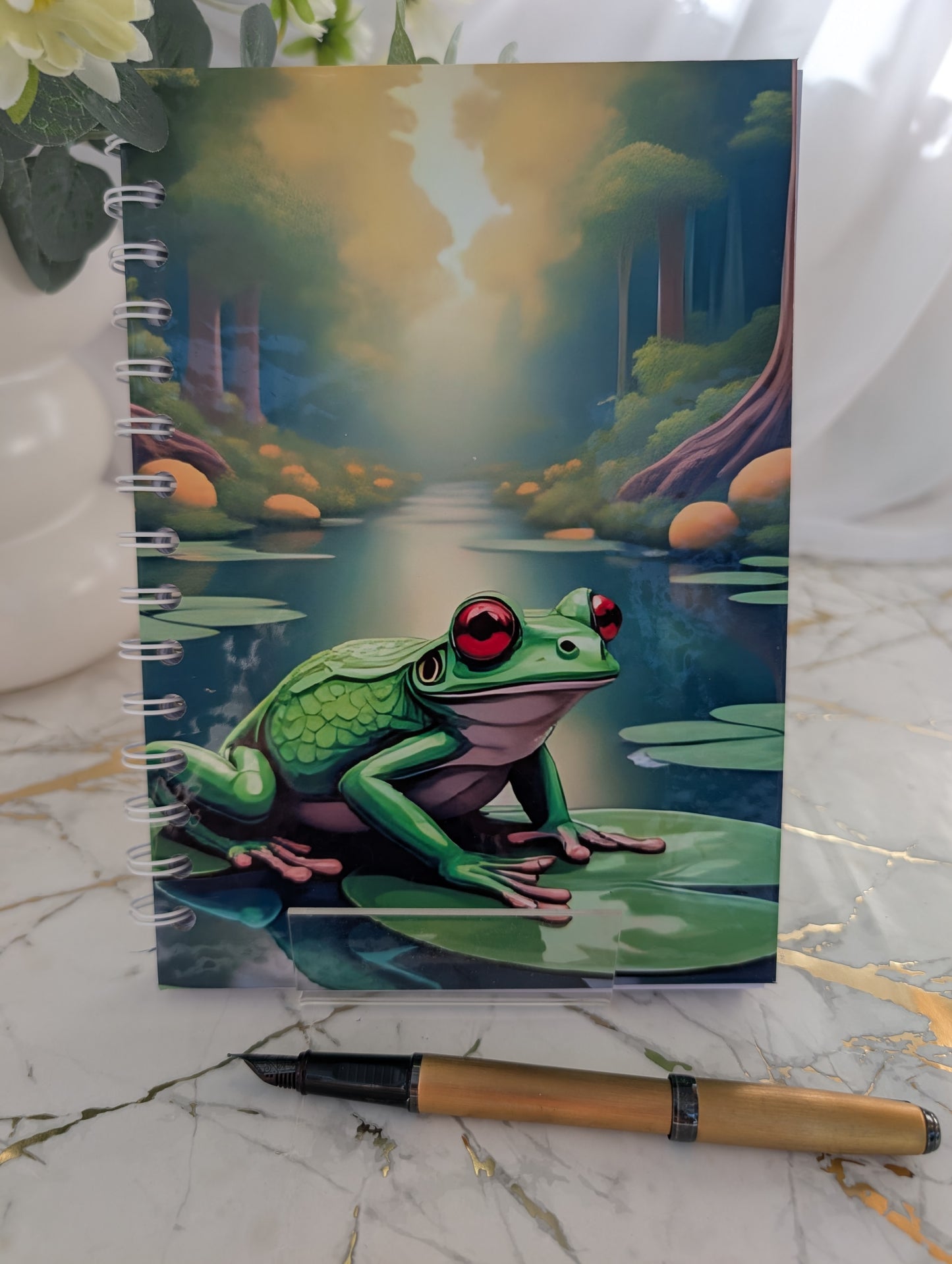 Close up front view of frog on lily pad hardback notebook