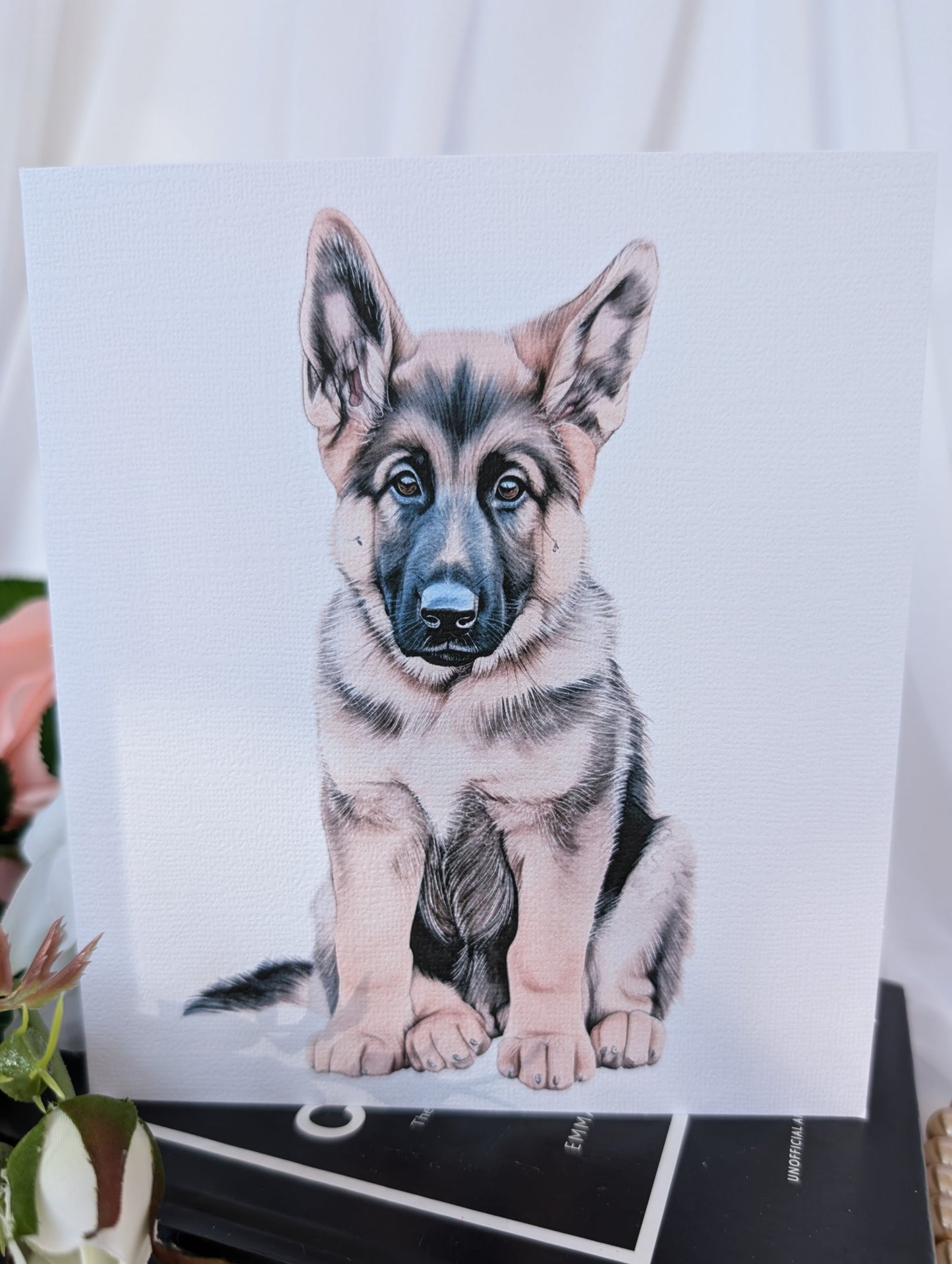 Close up view of white 300gsm linen effect card printed with a watercolour style image of a German Shepherd dog puppy