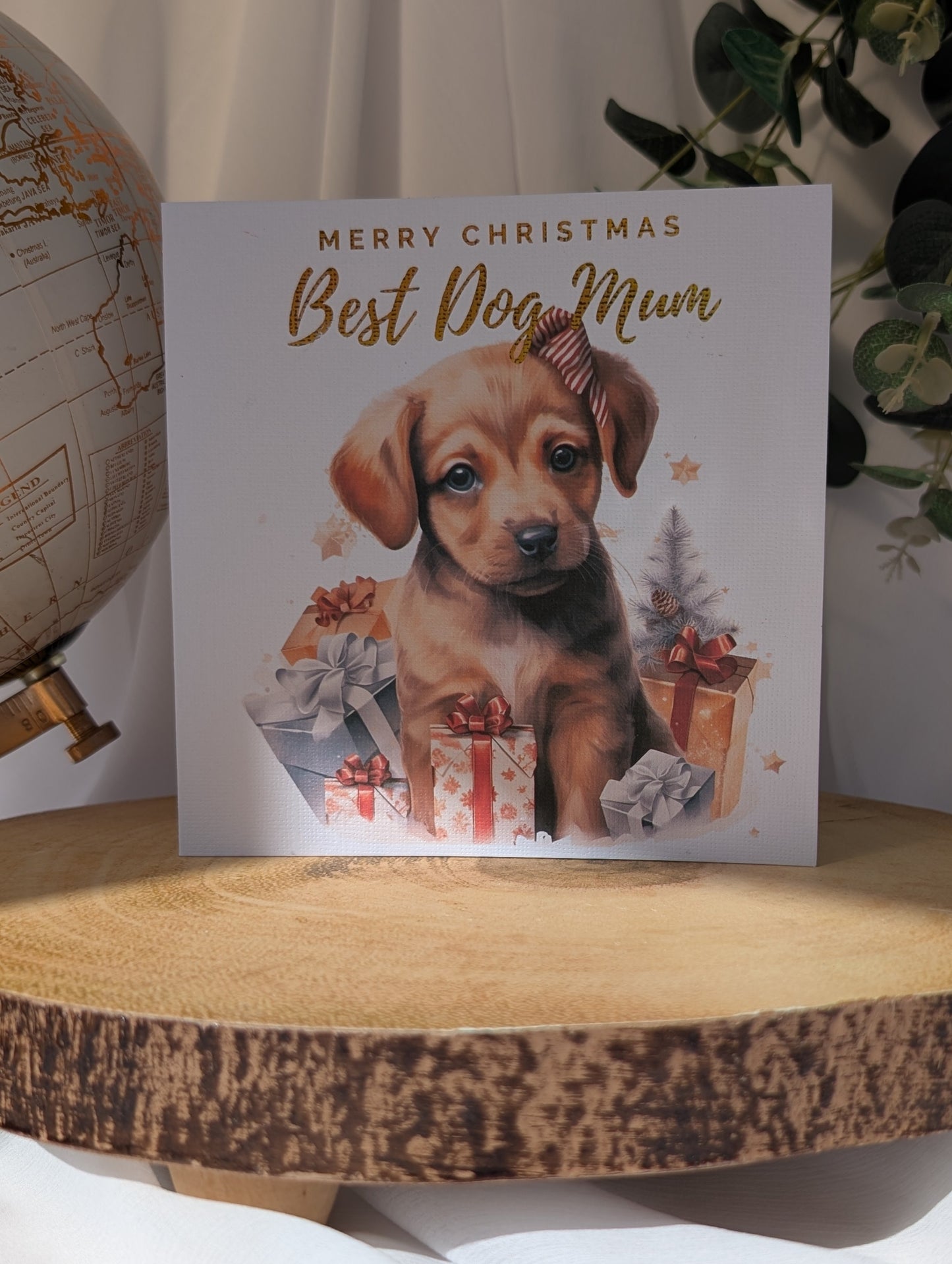 Labrador Christmas card with puppy and 'Merry Christmas Best Dog Mum' text on a wooden surface.