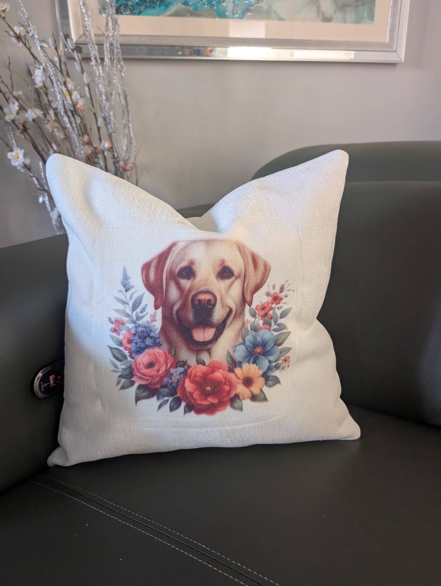Labrador retriever dog cushion made of cream linen effect fabric pictured on a green leather couch