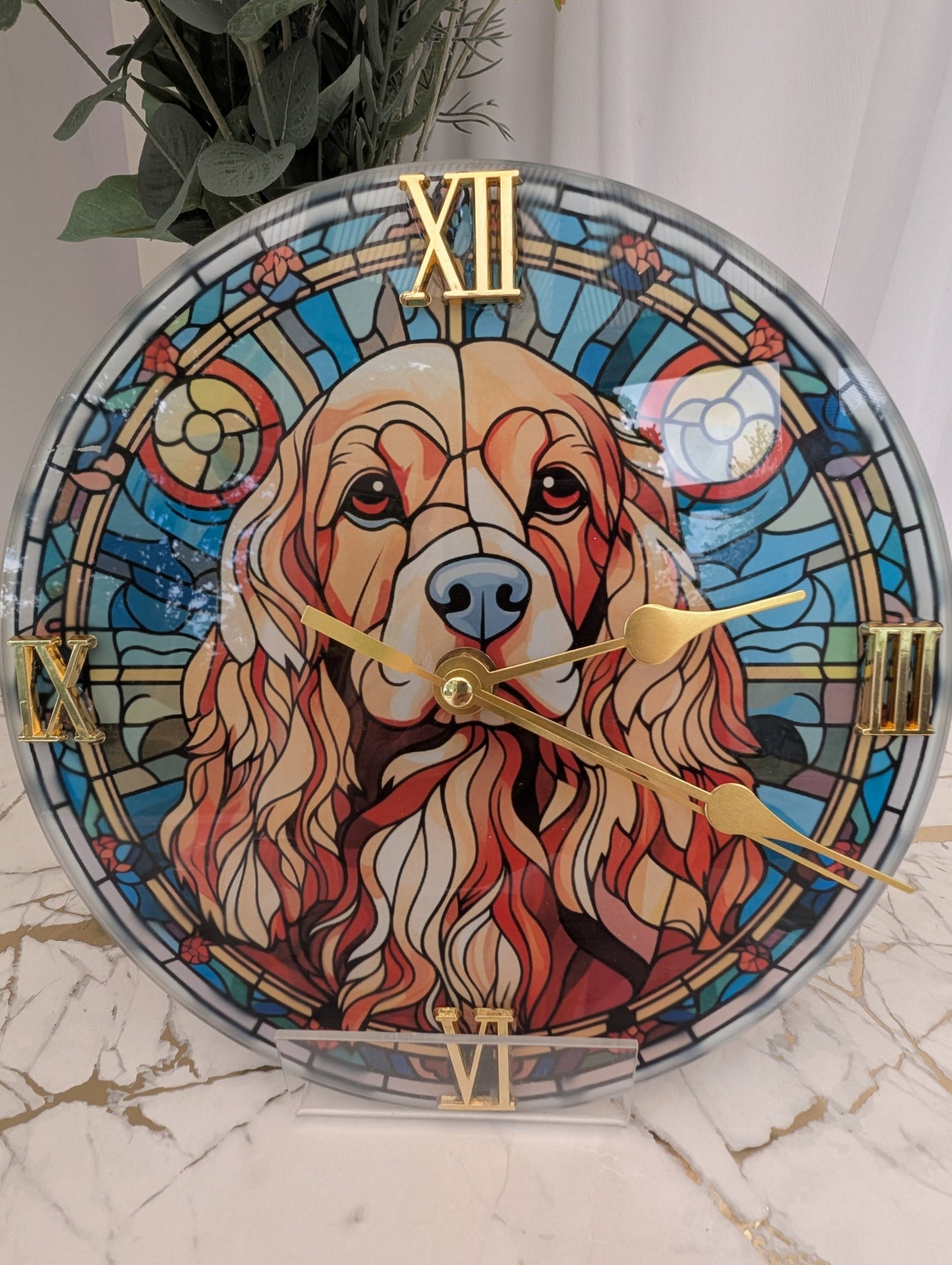 Close up of Cocker Spaniel wall clock in stained glass style, 20cm diameter round with gold Roman numerals and clock hands