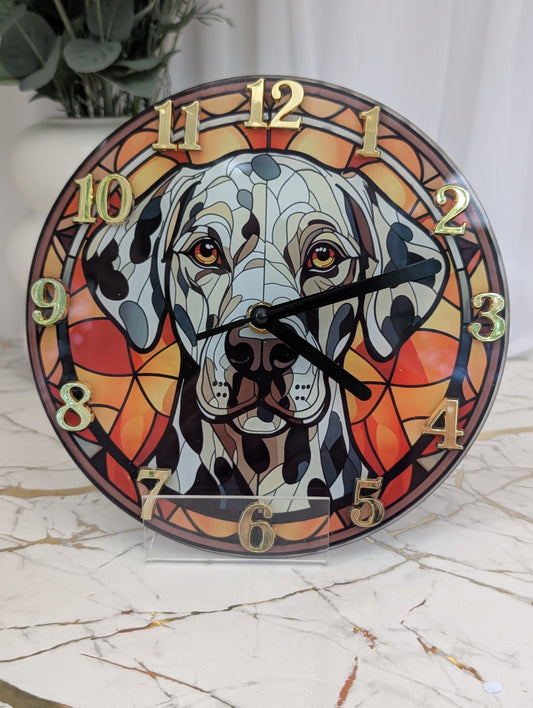 Dalmation wall clock, stained glass style in red tones, with gold coloured numerals and black hands.  20cm diameter round