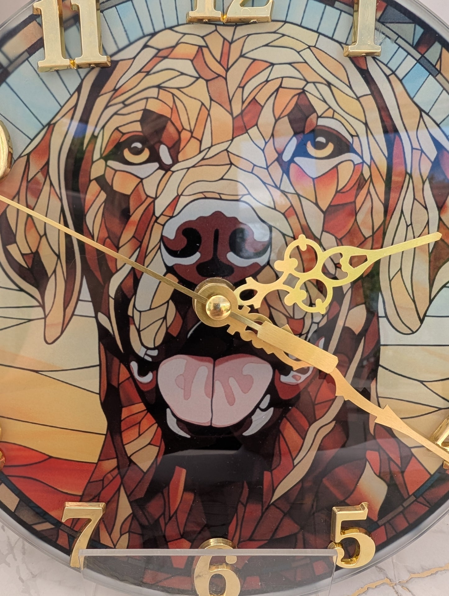 Detailed close up of 20cm diameter, round, stained glass style, Labrador wall clock with gold numbers and clock hands
