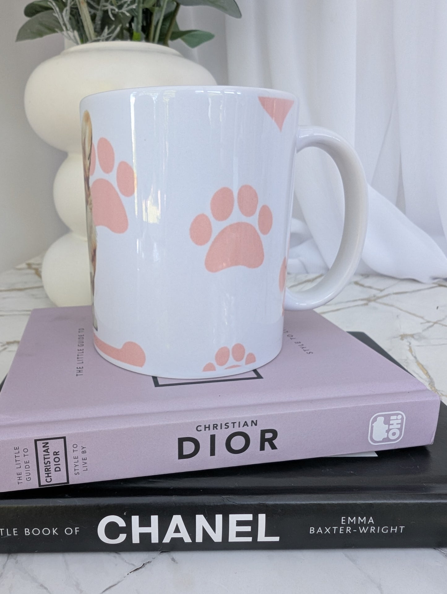 Left side view of white corgi mug showing pink pawprint background