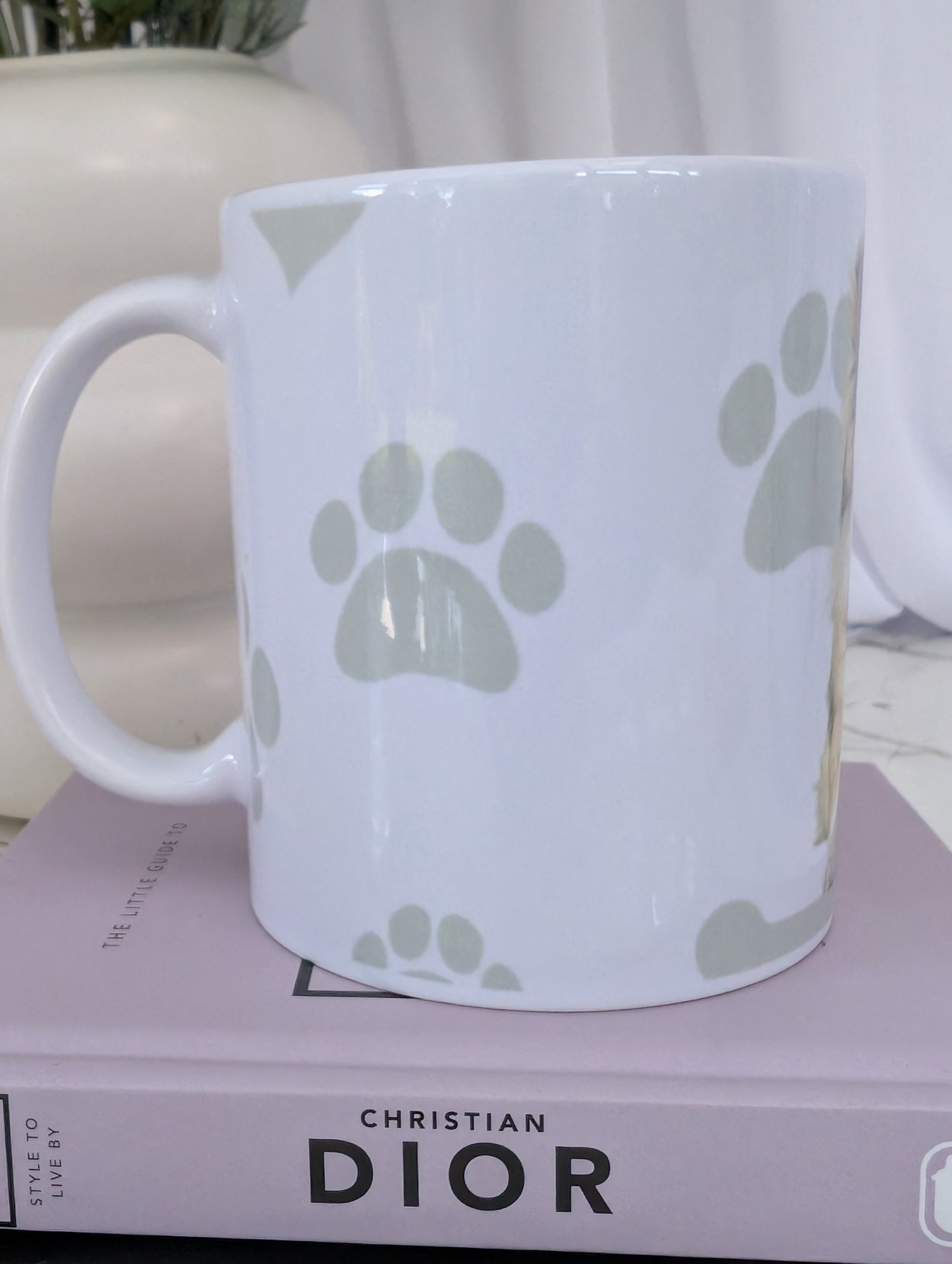 Right side view of 11oz white ceramic Border Collie mug, with watercolour style image of Border collie against a background of soft grey hearts, pawprints and bones