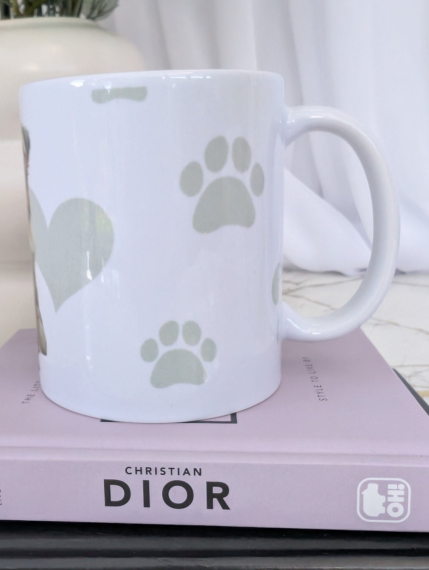 Left side view of11oz white ceramic Border Collie mug, with watercolour style image of Border collie against a background of soft grey hearts, pawprints and bones
