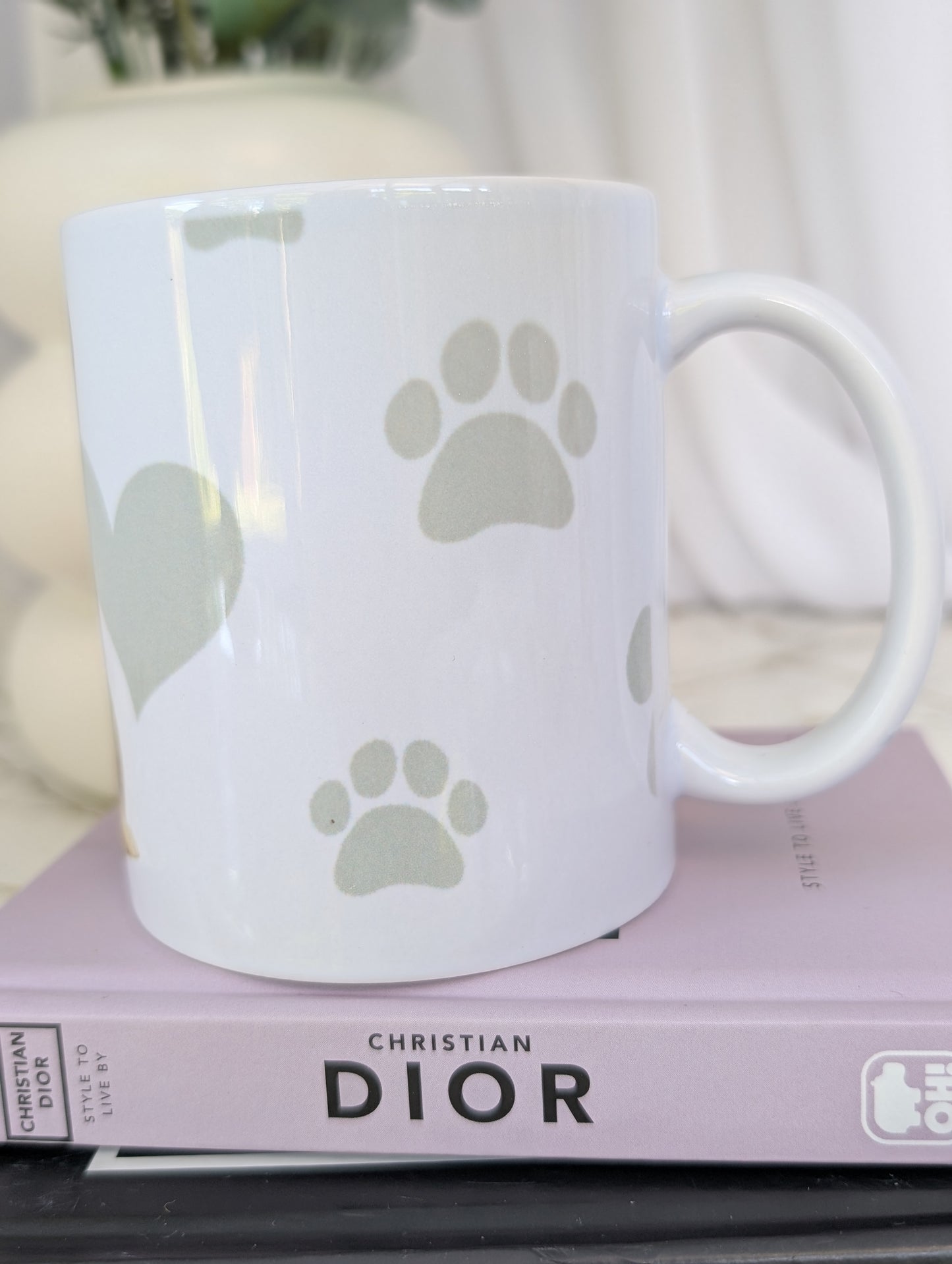 Left side view of Shiba Inu mug, watercolour style image on white ceramic mug with background of pale grey hearts, paws and bones