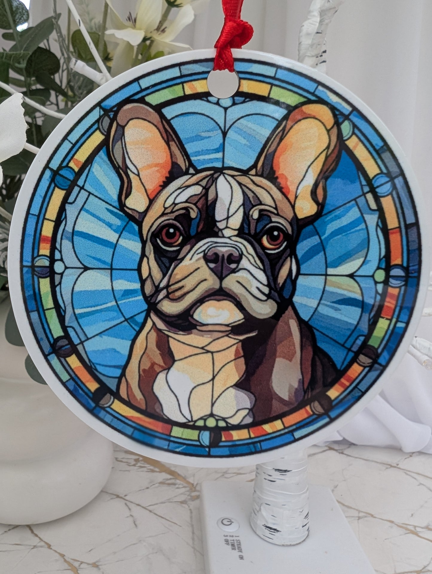 close up of round, aluminium, stained glass style French bulldog hanging ornament