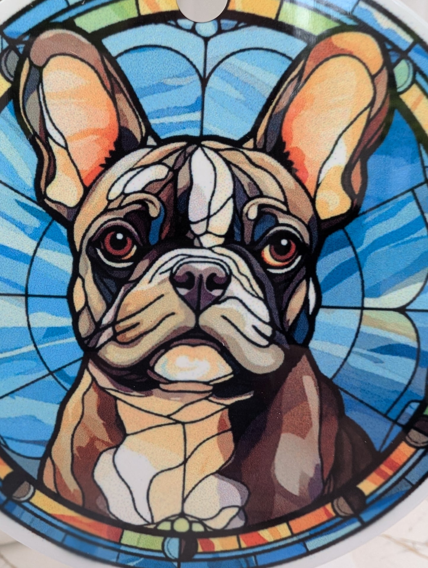 detailed close up of round, aluminium, stained glass style French bulldog hanging ornament