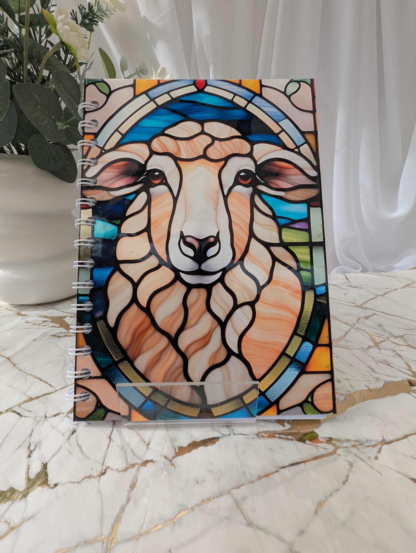 Bright colourful A5 spiral bound hardback sheep notebook in faux stained-glass style with 120gsm paper.