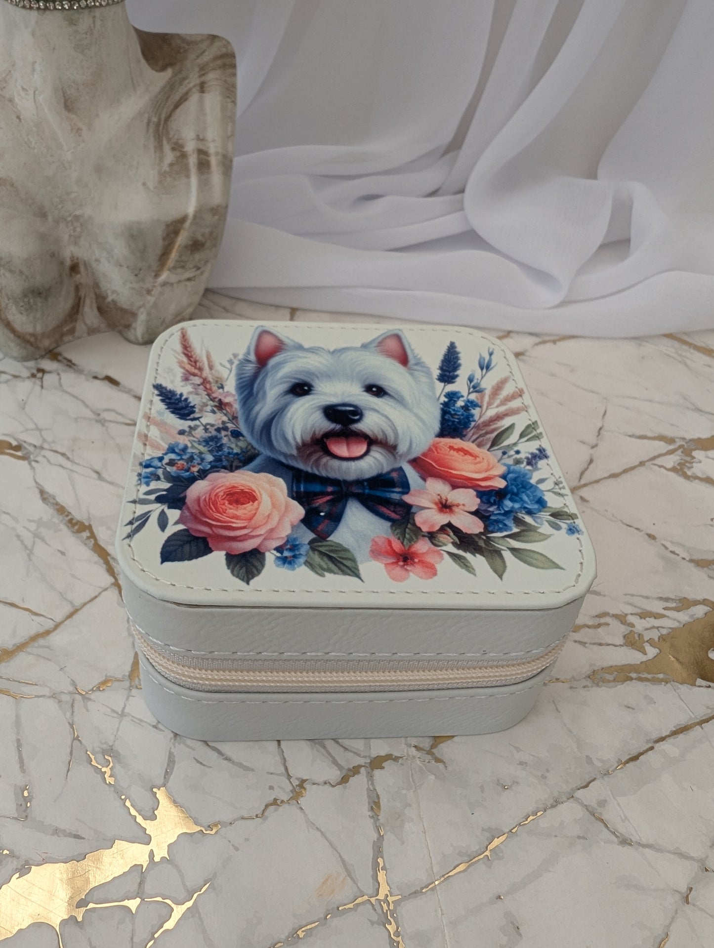 Top view of Faux Cream Leather Travel Jewellery Box with Western Highand Terrier peeping over flowers.