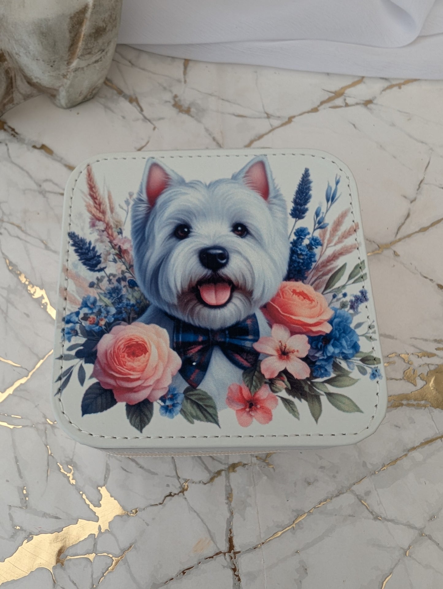 Close up of Faux Cream Leather Travel Jewellery Box with Western Highand Terrier peeping over flowers.