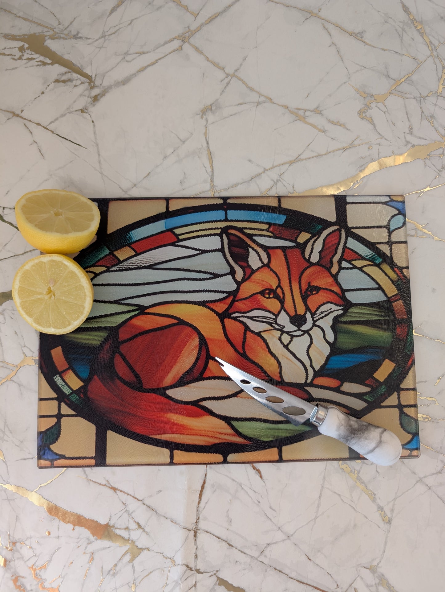 Top view of stained glass fox chopping board with knife and cut lemons