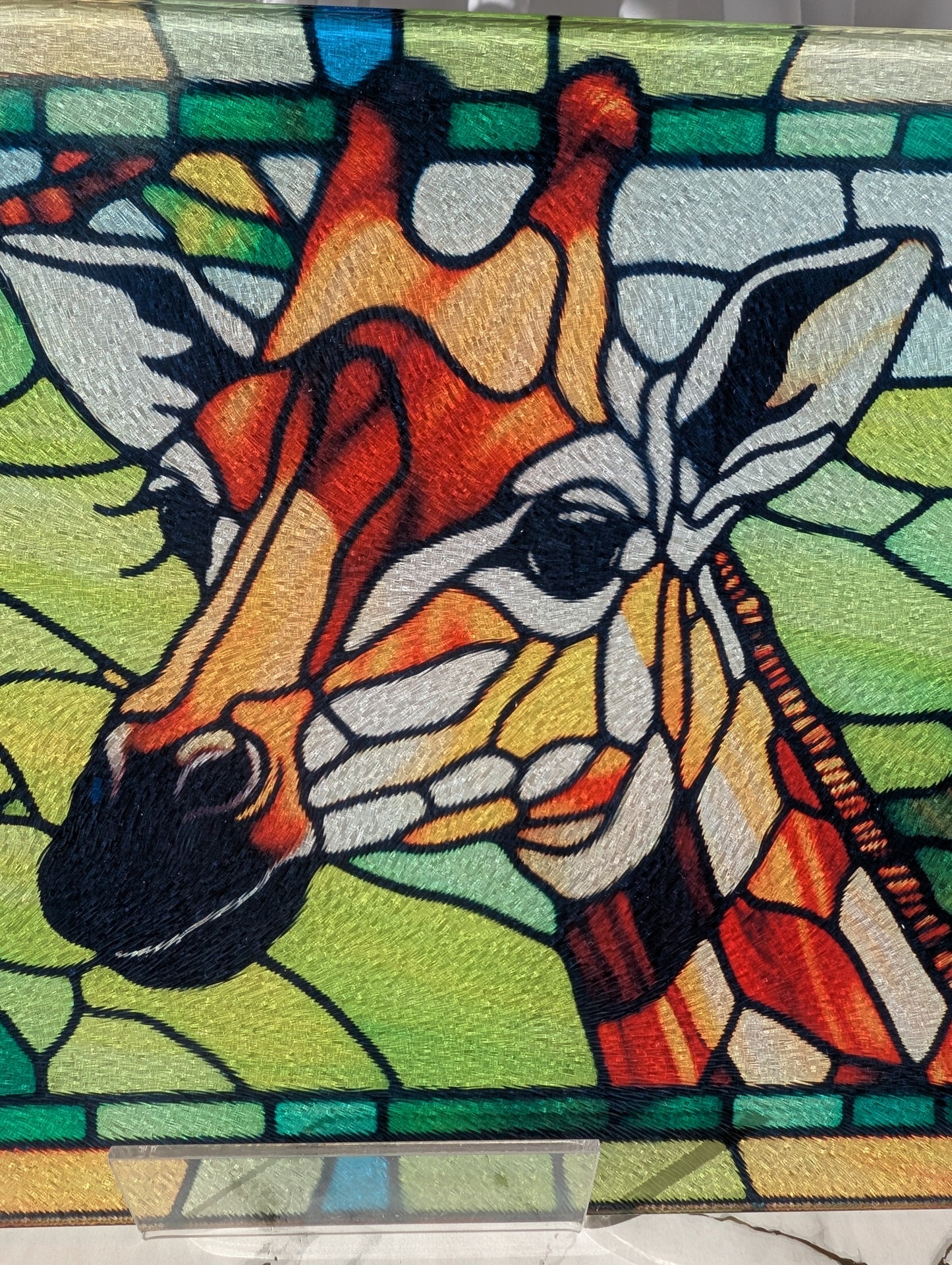 close up of stained glass style Giraffe chopping board. Made from toughened glass it's the perfect gift for giraffe lovers
