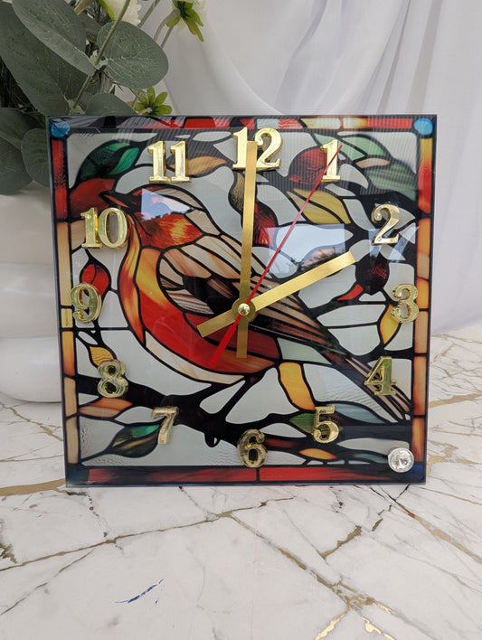 Stained glass-style freestanding robin clock with vivid red breast, nature-inspired design and gold numerals and hands