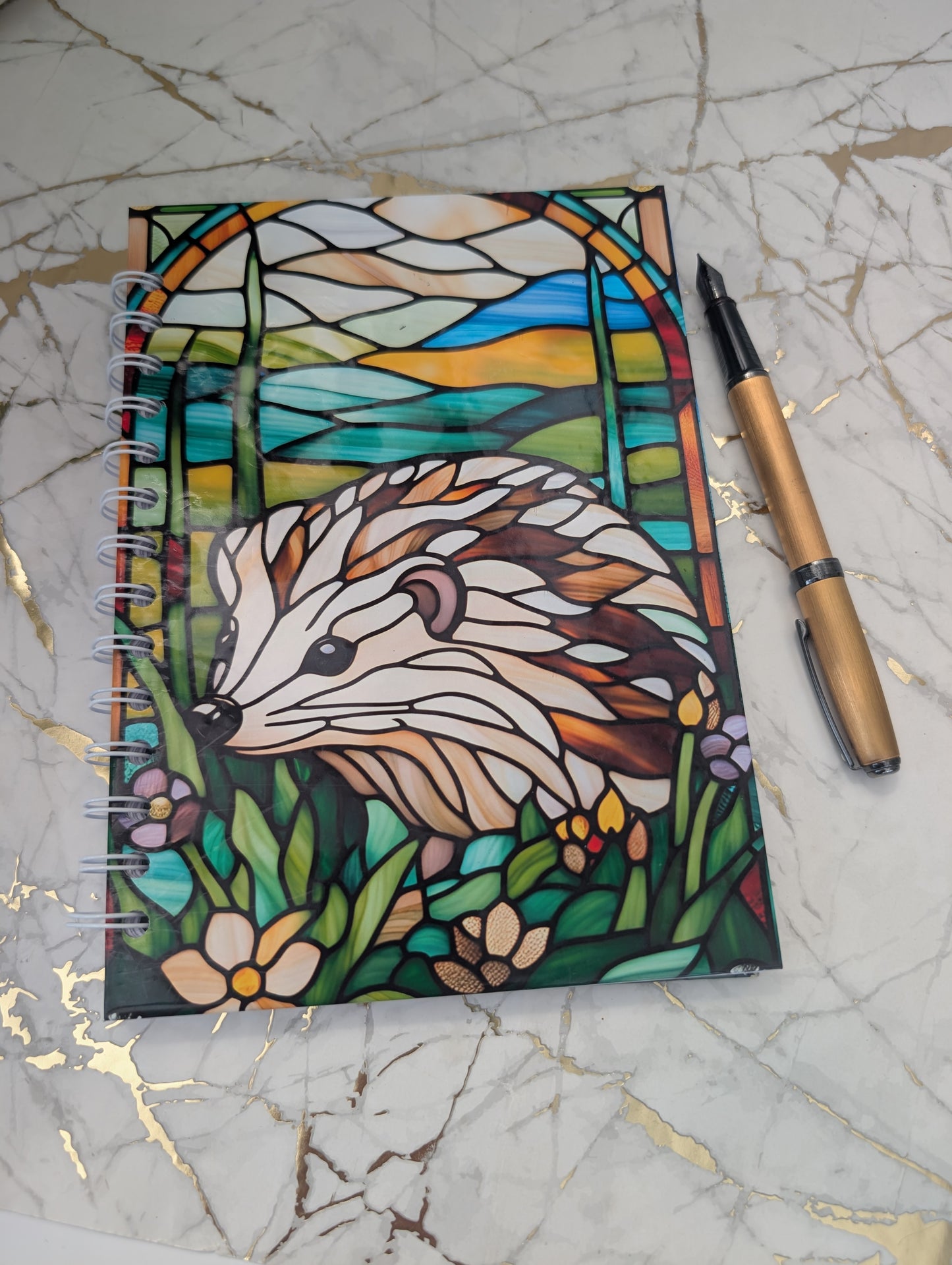 Top view of stained glass style hedgehog notebook.