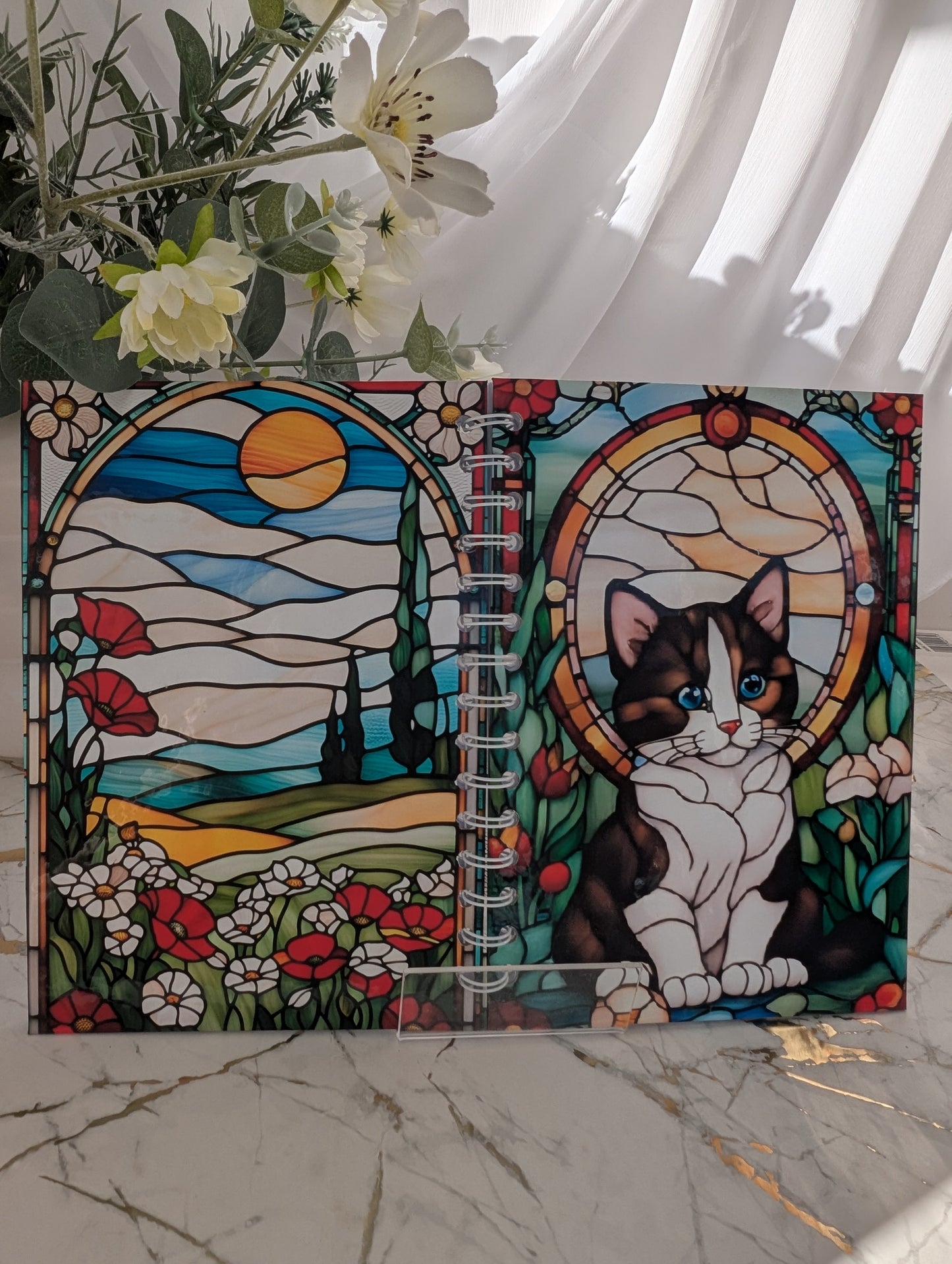 Front and back covers of quirky and colourful kitten notebook. Stained glass design, A5 size hardback