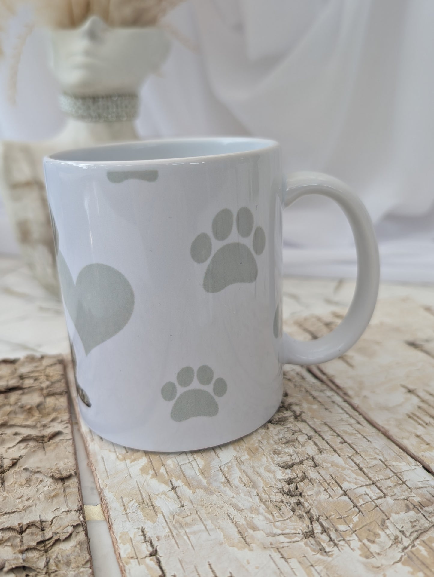 Left side view of White Ceramic Weimaraner Dog Puppy mug with background of soft grey hear, paw and bone print