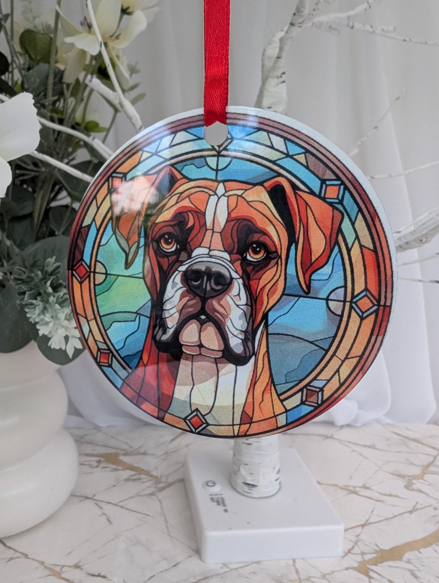 aluminium hanging ornament, 9cm diameter, printed with a Boxer Dog with blues and brown stained glass style print background.  