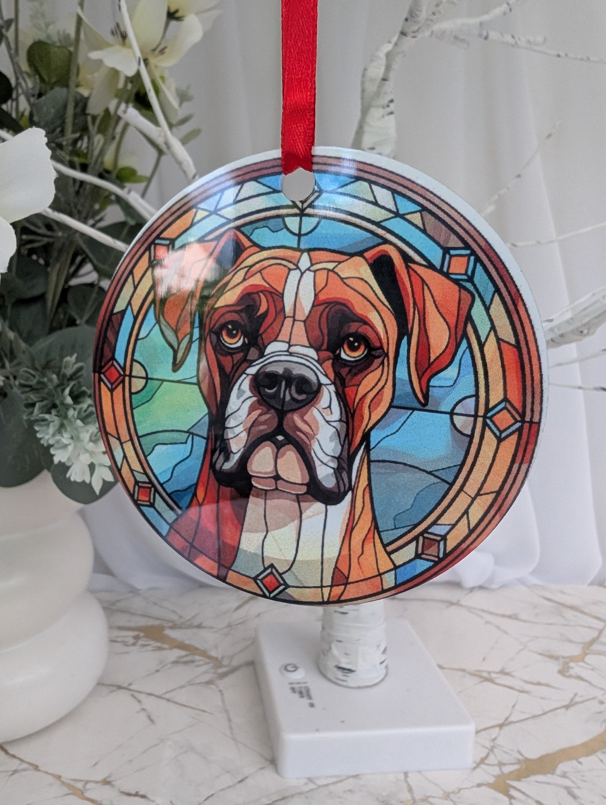 aluminium hanging ornament, 9cm diameter, printed with a Boxer Dog with blues and brown stained glass style print background.  