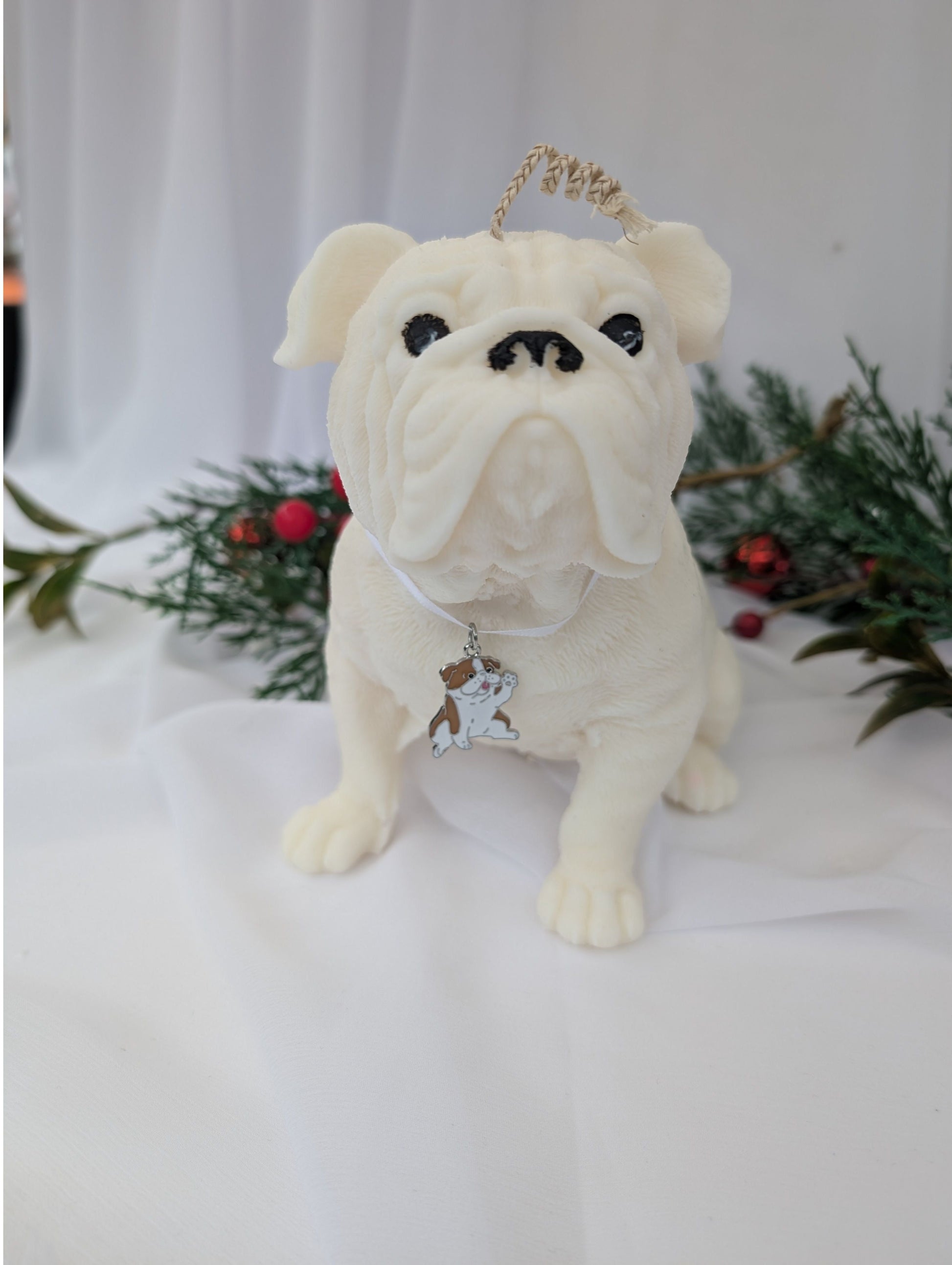 Front view of hand poured moulded British Bulldog Candle with white ribbon and British bulldog charm around its neck