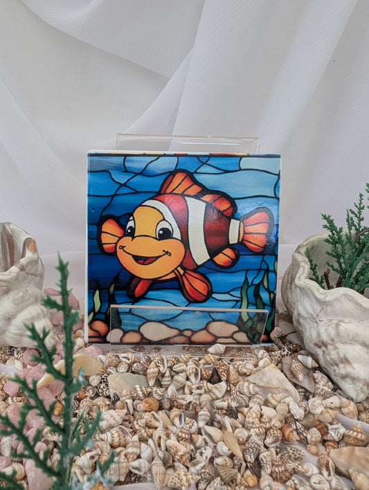 Ceramic Clownfish Stained glass effect coaster  on a bed of shells and small plants
