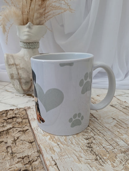 Right side view of white Rottweiler mug with paw prints on a wooden surface