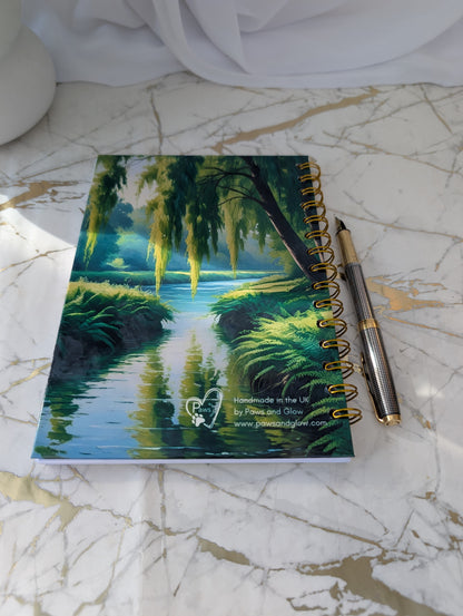 Back cover of chocolate labrador notebook by Paws and Glow.  Showing a peaceful  river with willow trees.