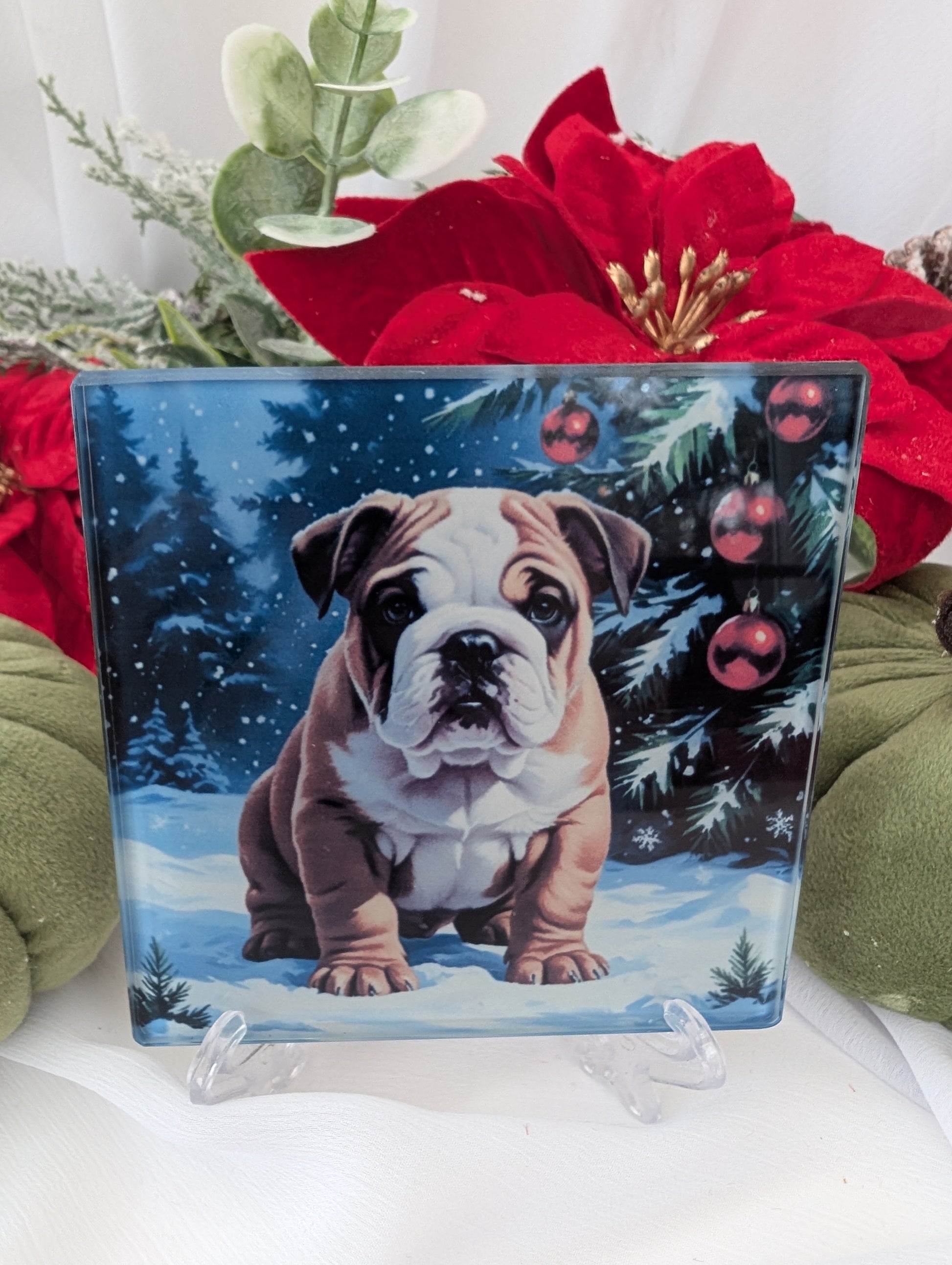 Decorative glass coaster with a cute bulldog in a winter scene surrounded by festive decorations.