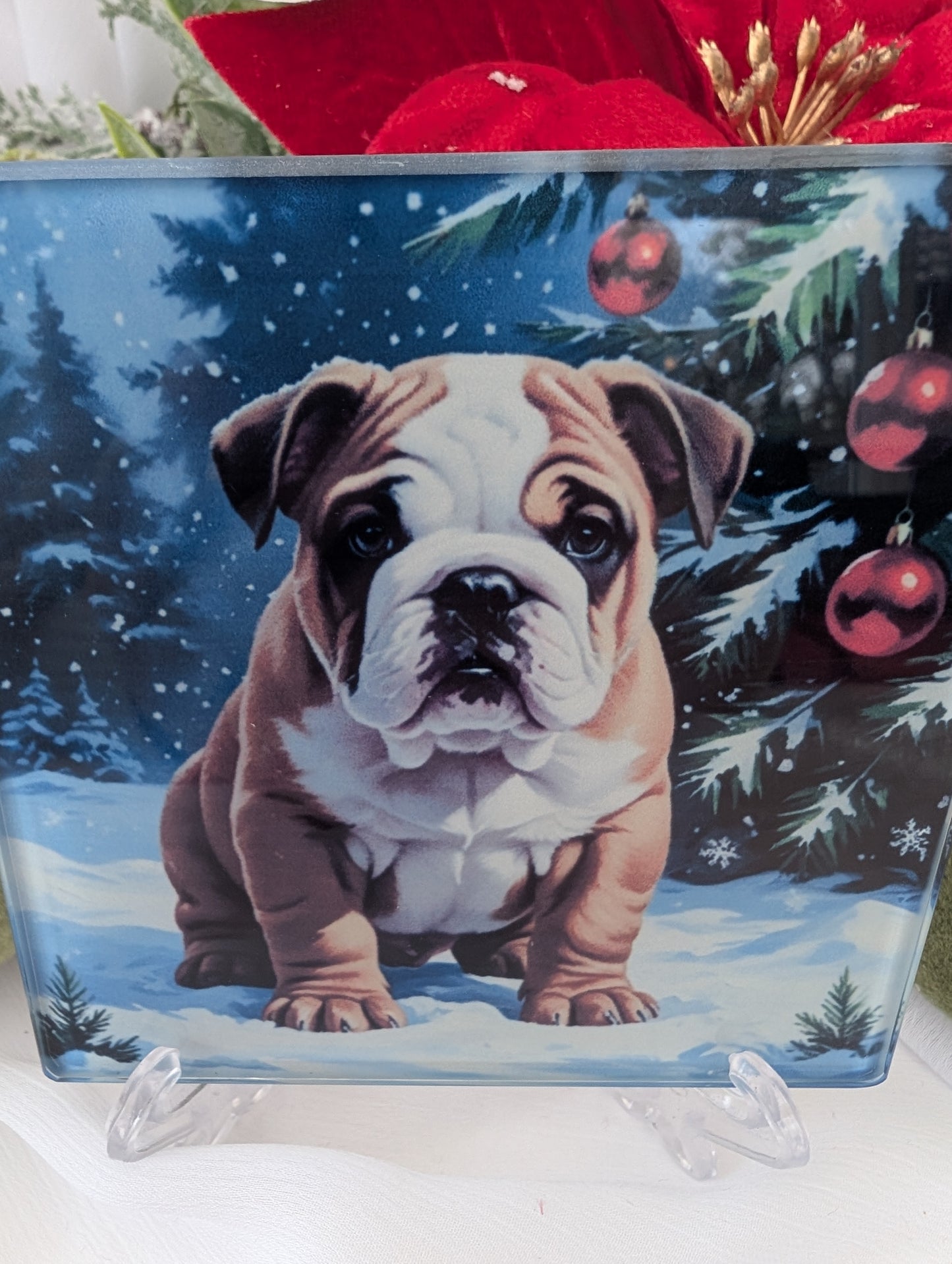 Decorative glass coaster with a bulldog puppy design in a winter scene with Christmas trees and ornaments.