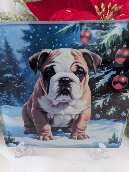 Decorative glass coaster with a bulldog puppy design in a winter scene with Christmas trees and ornaments.