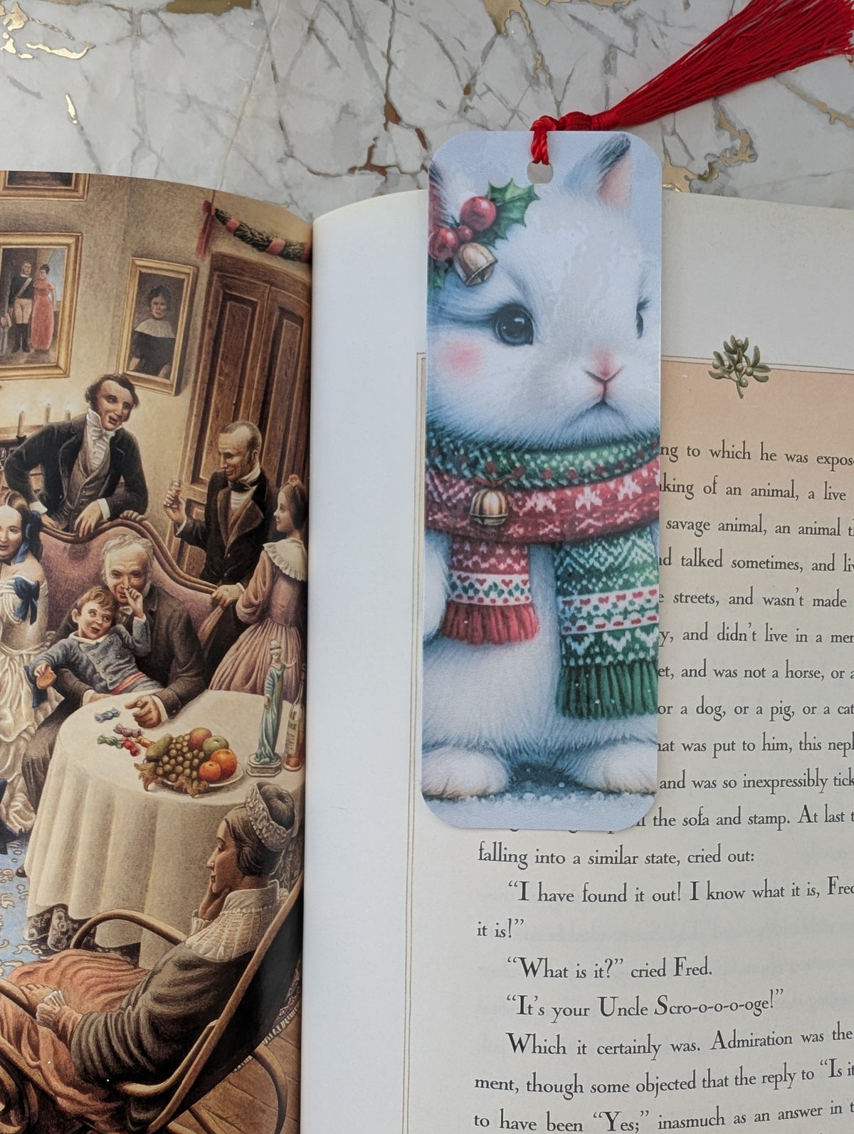 Cute white Christmas bunny bookmark shown on an open copy of illustrated Christmas Carol