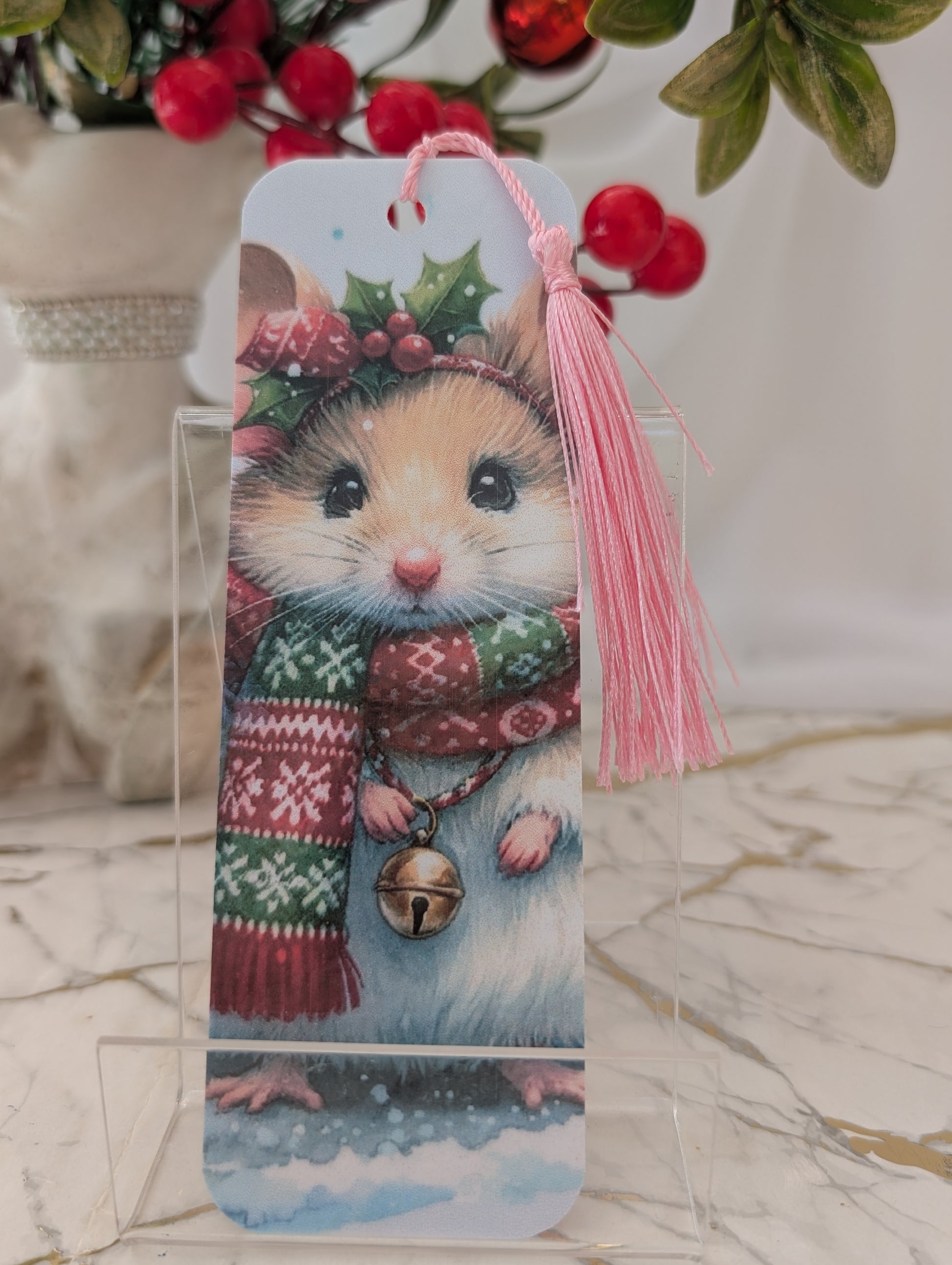 Laminated Christmas bookmark with cute Christmas mouse illustration, adorned with holly and a Christmas scarf and bell