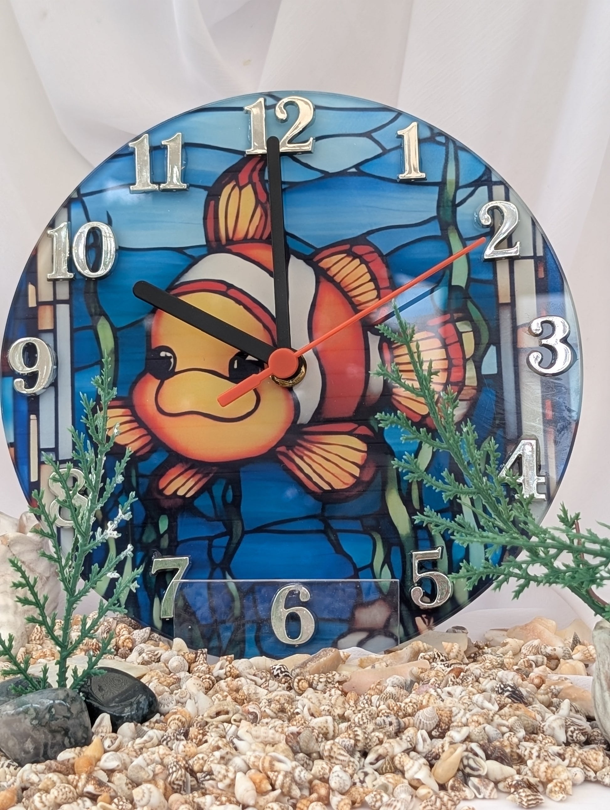 Decorative clock with a clownffish design on a white background